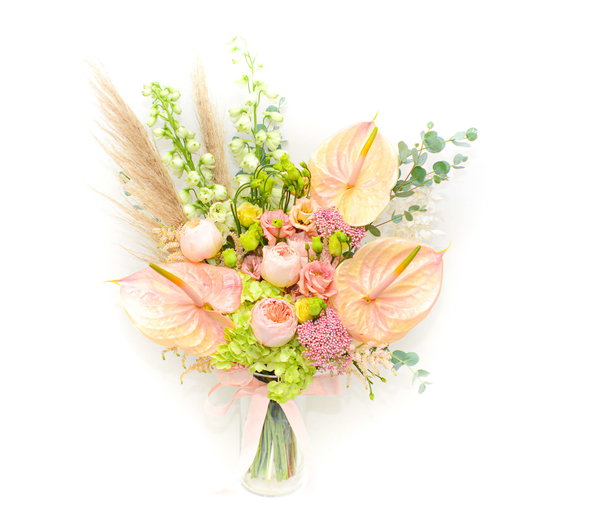 Anette - Front side bouquet! Whimsical and elegant, Anette arrangement features a lovely mix of white, green and pink-peach flowers. With delicate blush anthurium, peach garden roses, soft white delphinium, green hydrangea and pampas grass. This lush bouquet manages to find a happy balance between understand and dramatic. Anthuriums Symbolize Hospitality Due to their open, heart-shape and long-lasting characteristics they are popular as hostess or hospitality gifts.