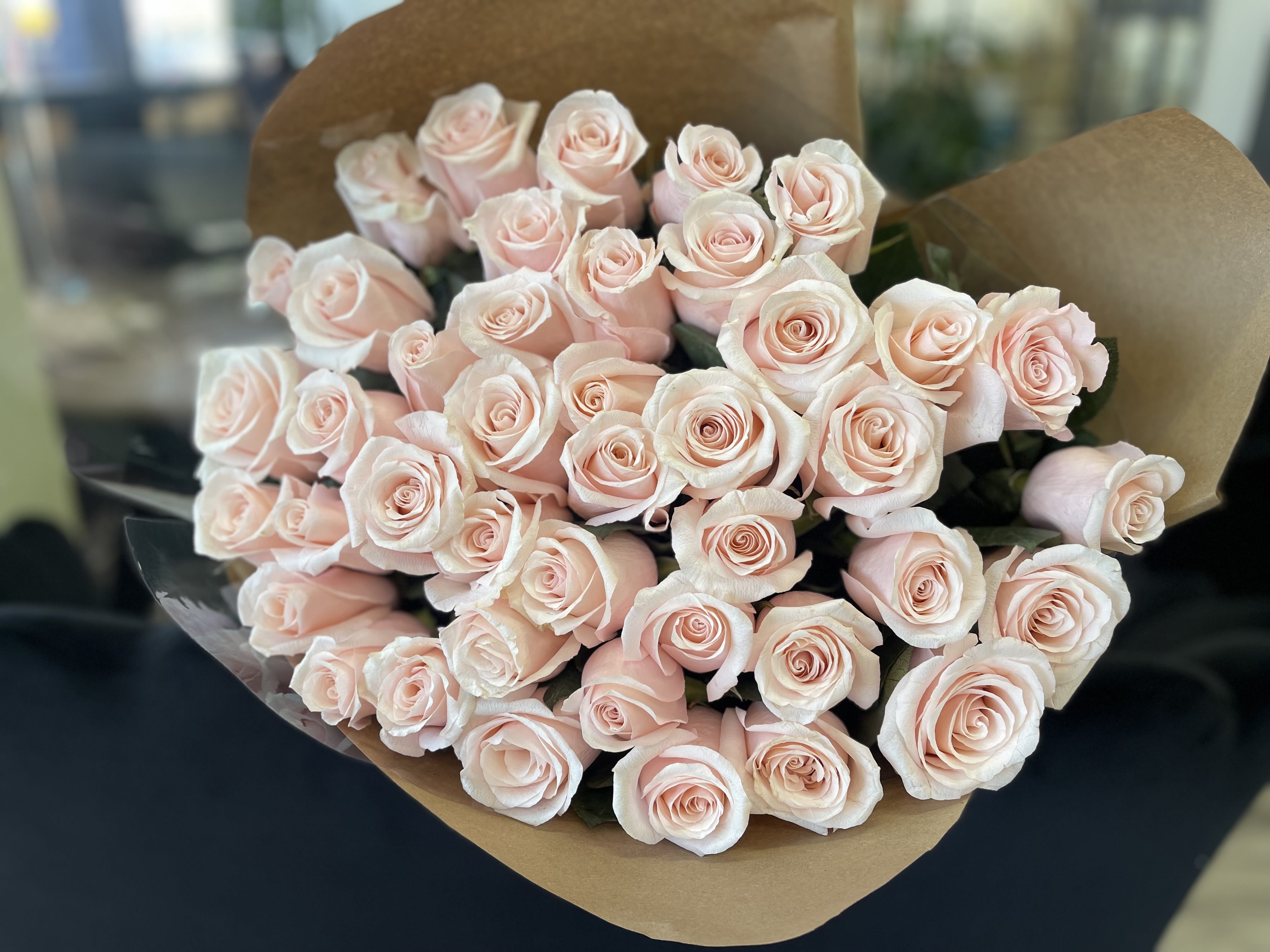 50 Blush Pink Roses Bouquet - A beautiful bouquet of premium 50 blush pink roses, finished with a perfectly matching satin bow for a refined, elegant look. This romantic arrangement is perfect for Valentine’s Day, anniversaries, or special occasions. Wrapping Upgrade: For an additional $10, the bouquet can be wrapped in premium wrapping paper.  Available Sizes:  Deluxe: 150 stems  Premium: 200 Stems    Some florals are seasonal, if a particular flower will not be available due to season, we will substitute for similar flower, composition, color pallet and value of the arrangements as closely as possible. All effort to create a floral arrangement as close to the photo shown, the actual arrangement may vary slightly in its appearance from the photo shown. If you have any questions about your order, we welcome you to call us in or email    Holiday Delivery:  Same-day delivery available. Deliveries are made throughout the day based on routing.