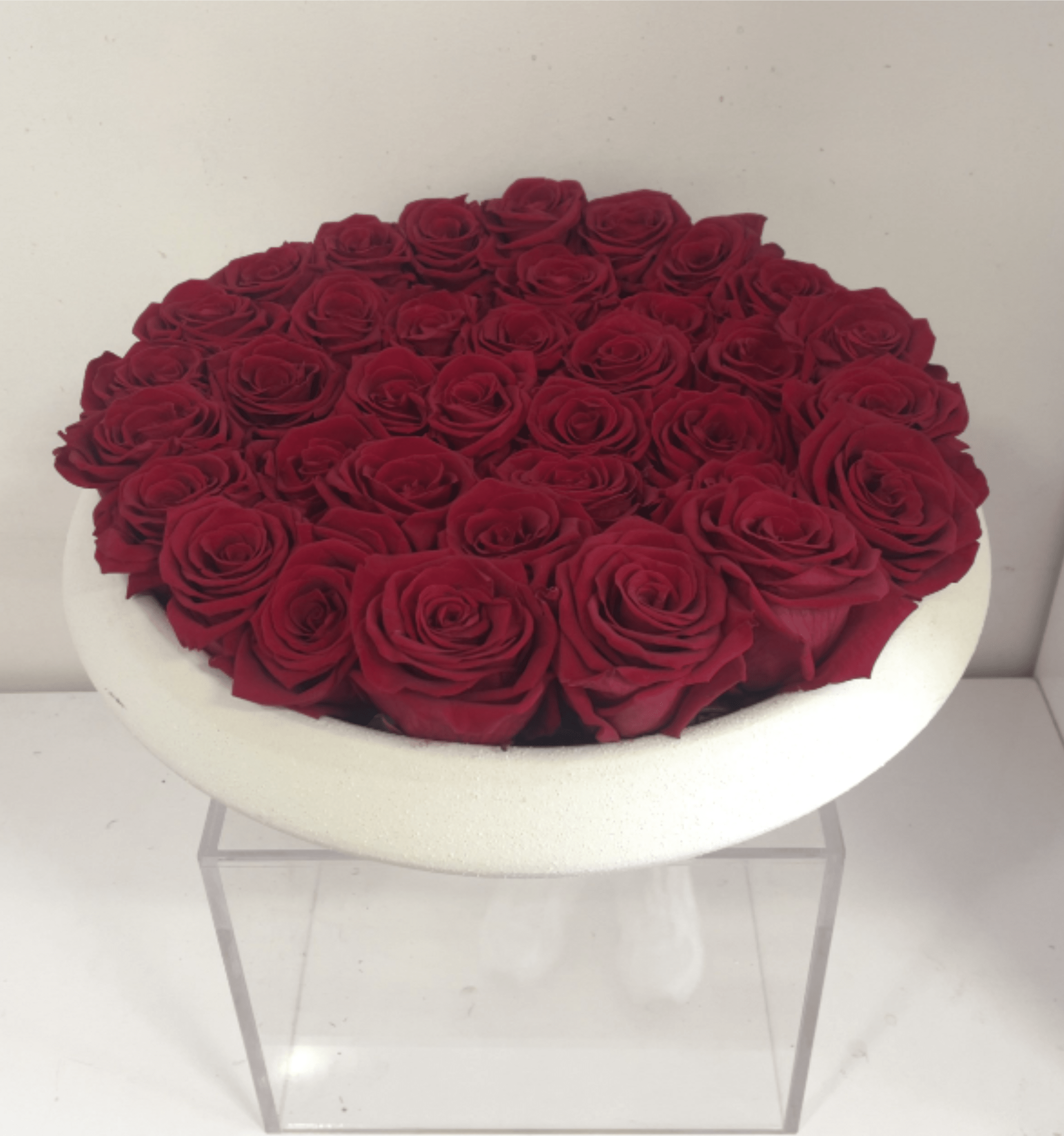 Eternal Roses in White Ceramic Vase - Elegant eternal roses arranged in a white ceramic vase, designed for lasting beauty without water or maintenance. This luxury preserved rose arrangement makes a timeless gift, perfect for romantic moments and stylish home décor.  Our Eternal Roses are real preserved blooms, designed to maintain their beauty for up to several years under proper indoor conditions. As a natural product, subtle variations in texture and tone may occur over time, enhancing the unique character of each piece.  To preserve their beauty, keep roses indoors, away from moisture and direct sunlight. Do not water. Handle gently, petals are real and delicate. With proper care, your roses will maintain their elegance for years to come. Exact flowers may vary slightly based on availability while maintaining overall color palette, size, and style.  Holiday Delivery:  Same-day delivery available. Deliveries are made throughout the day based on routing.     