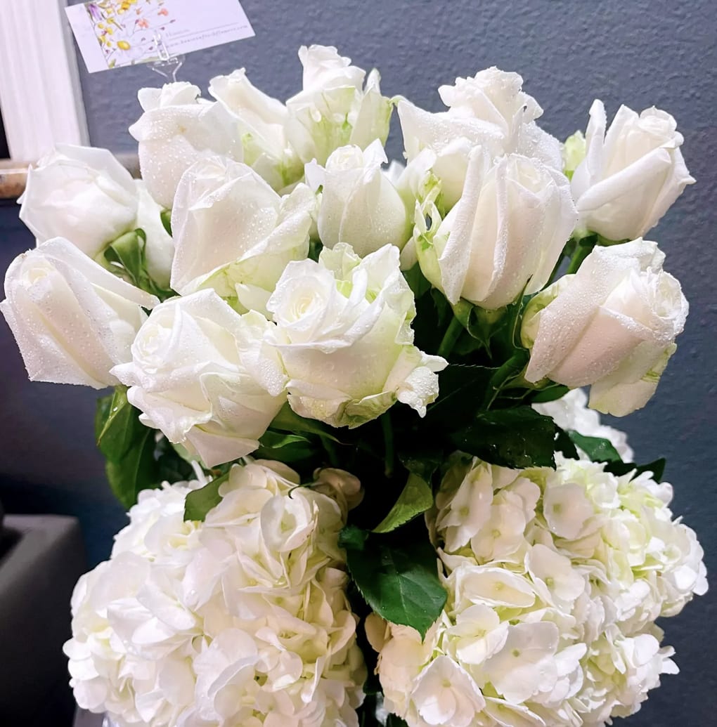 Elegant white roses and hydrangeas - 2 Dozen- Standard Bouquet 3 Dozen- Deluxe Bouquet A grand arrangement of elegant white roses, hydrangeas and greens in a vase. This Amazing flower arrangement is the perfect gift for any occasion, and is sure to make anyone feel loved and appreciated.
