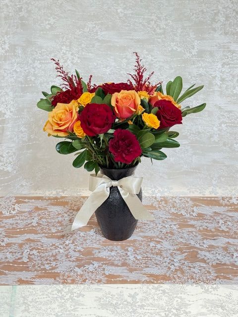 The Lions Bloom - HP inspired arrangement. A mix of gold toned roses, burgundy carnations and red garden roses. 