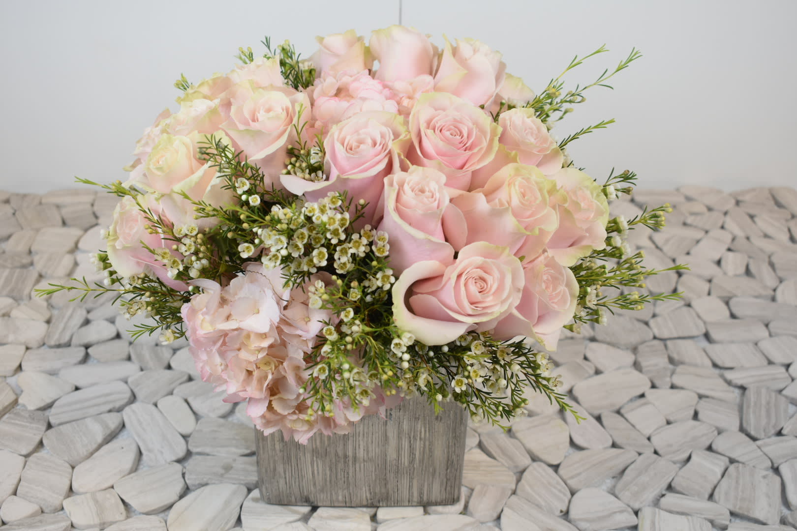 Rossie  - This Rossie floral arrangement comes in a silver ceramic vase  with light pink roses,  light pink hydrangeas, and a touch of white wax Perfect for  birthday flowers anniversary flower  just because flowers  congratulations flowers  Get well flowers  Christmas flowers Valentines Day flowers Mother's Day flowers