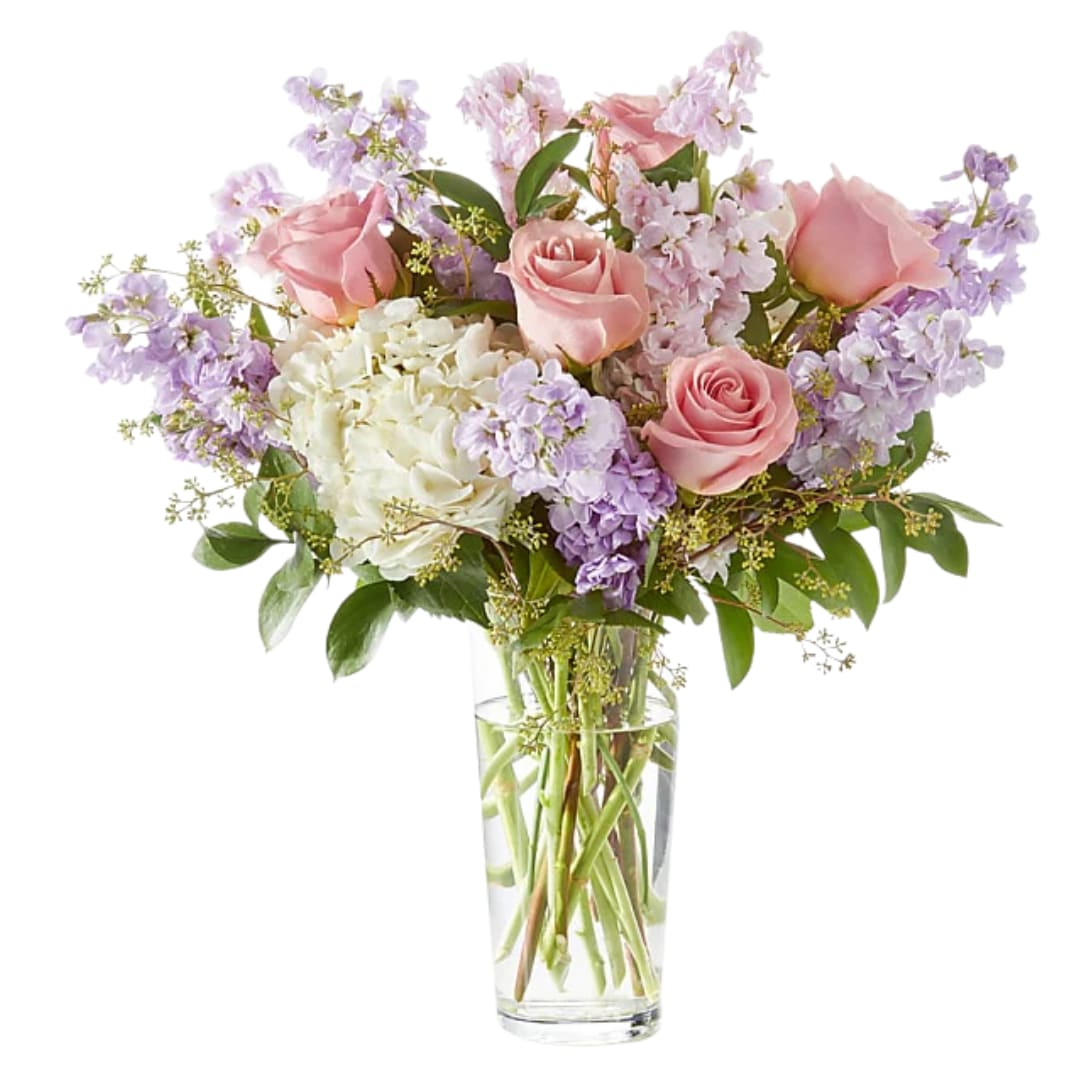 Poetic Bloom - Soft, romantic, and effortlessly elegant—Poetic Bloom is a graceful blend of pastel blooms designed to soothe and delight. Featuring delicate pink roses, lavender-hued stock, creamy white hydrangeas, and wisps of seasonal greenery, this arrangement captures the quiet beauty of a spring morning. Perfect for celebrating love, offering comfort, or simply brightening someone’s day with a touch of gentle charm.