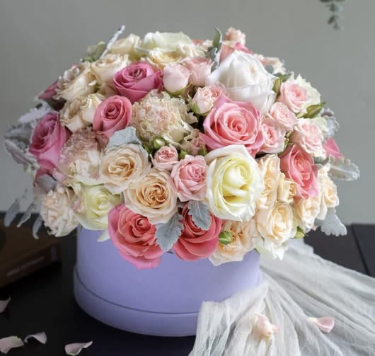 Always On My Mind - Soft, romantic, and effortlessly chic — this luxury pastel flower box is designed to brighten any special moment. Featuring a stunning blend of premium roses, spray roses, lisianthus, and delicate hydrangea accents in dreamy shades of blush pink, peach, ivory, and white, it’s artfully arranged in a stylish lavender hat box for a truly elevated look.  Perfect for birthdays, anniversaries, thank-you gifts, romantic occasions or just-because surprises, this arrangement delivers beauty and sophistication in every petal. Available with same-day flower delivery in Norfolk, VA Beach and Hampton Roads, it’s the ideal way to make any day unforgettable.