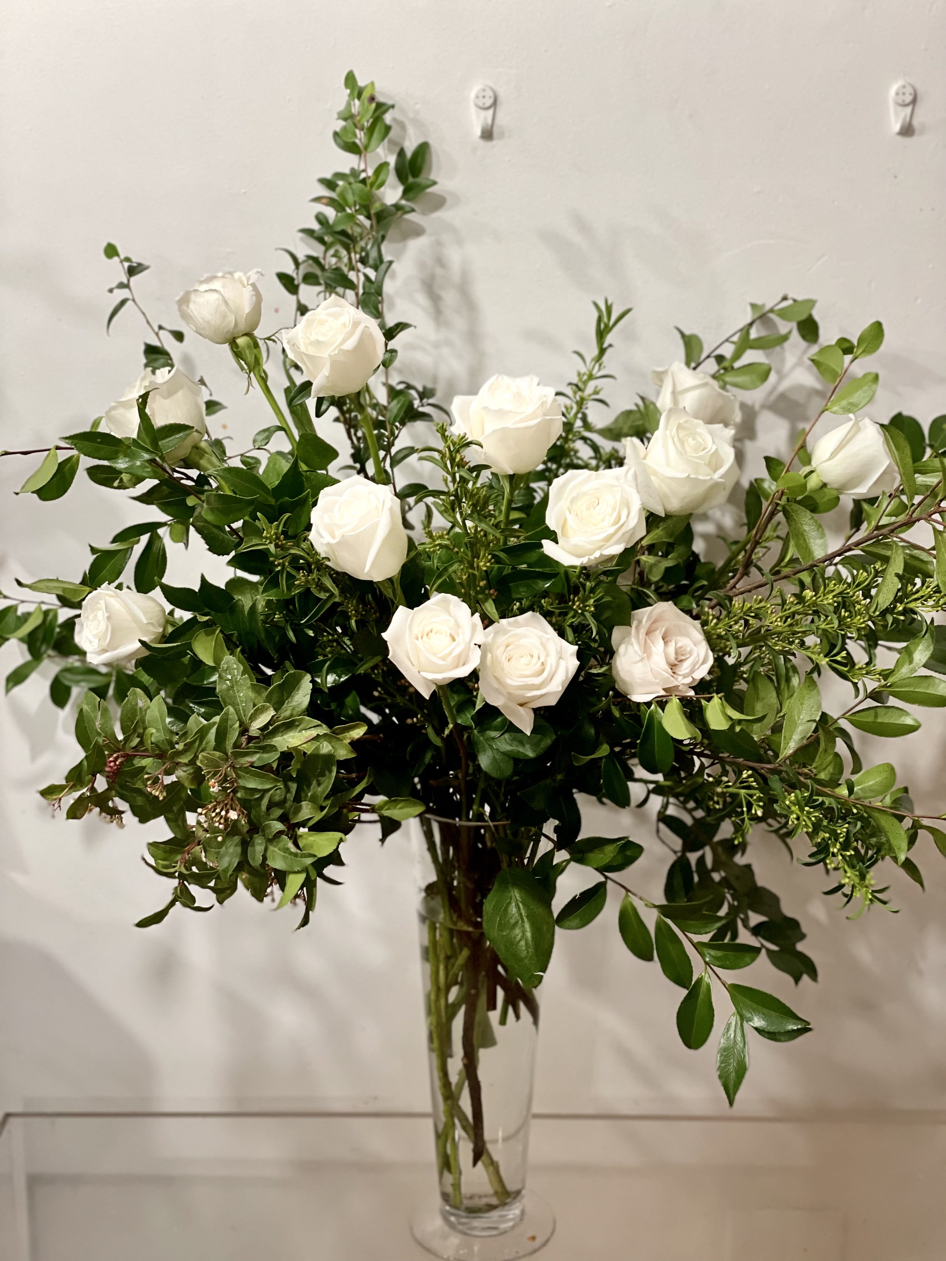 Big LOVE!  - A 1.5 dozen white high petal count roses in a tall vase.   Select DELUXE for 2.5 dozen roses  Select PREMIUM  for 3.5  dozen roses   NOTES: We will choose the freshest and most interesting ingredients at the market to make this arrangement shine. Vessels may be substituted depending on availability.  