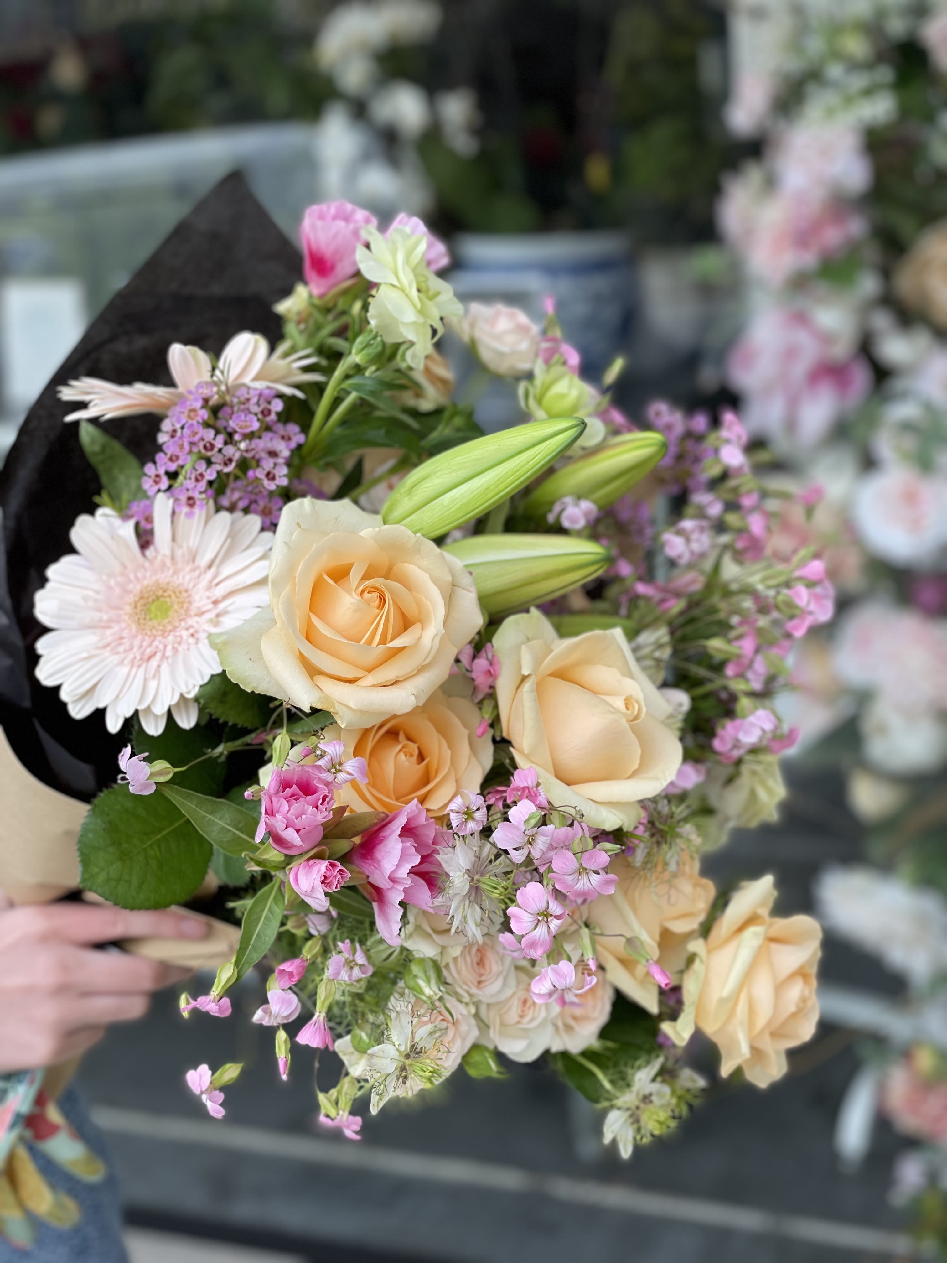 Designers Choice SPRING BOUQUET - Fresh paper wrapped with a bow! We will select the sweetest arrangement for your loved one. Trust us with the blooms and we will deliver the best for you.  NOTES: We will choose the freshest and most interesting ingredients at the market to make this arrangement shine. Vessels may be substituted depending on availability. 