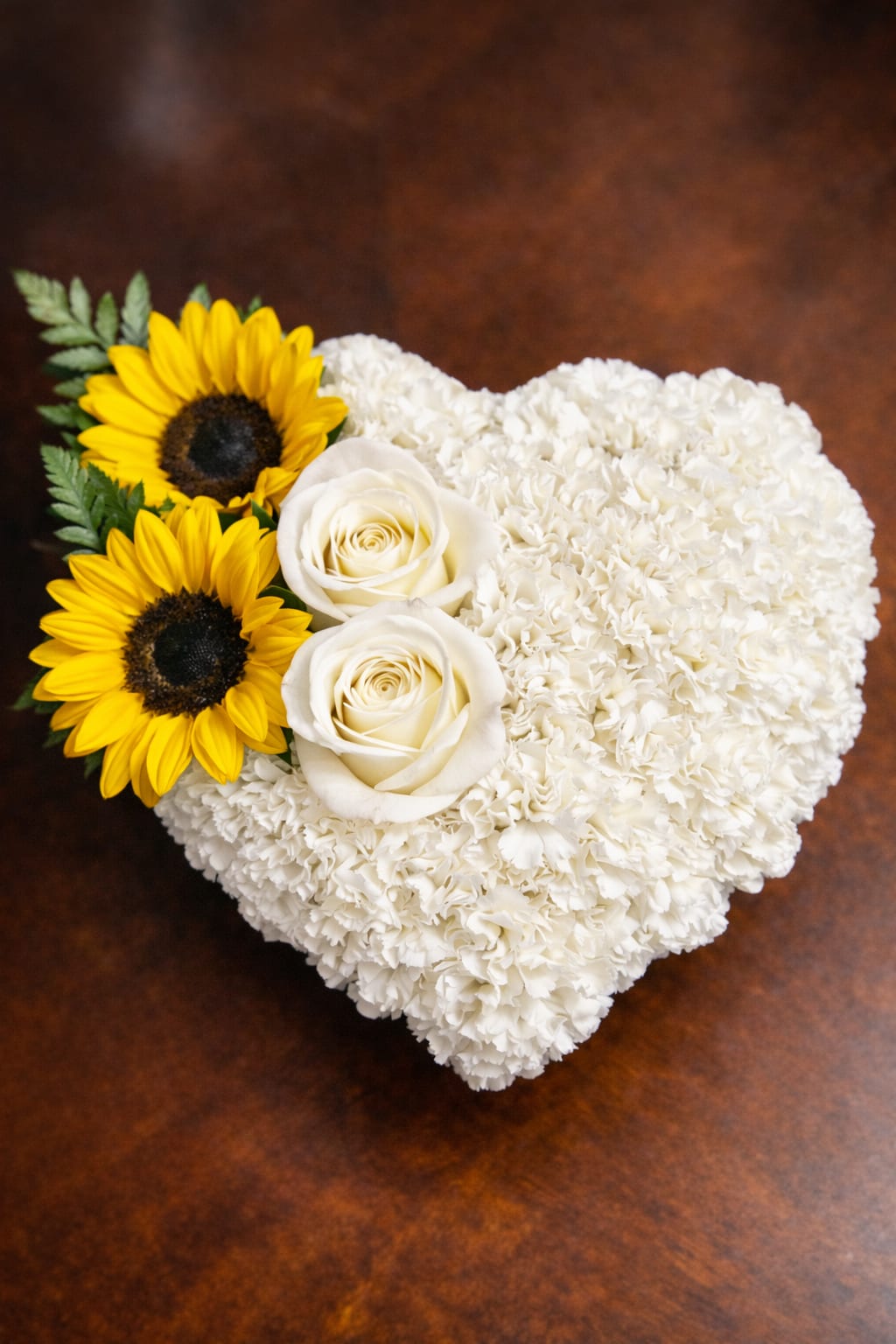 Golden heart elegance  - Golden Heart Elegance A beautiful heart-shaped arrangement featuring soft white carnations, elegant white roses, and cheerful yellow sunflowers. Designed to symbolize love, purity, and warmth, this arrangement is perfect for special moments and heartfelt occasions.