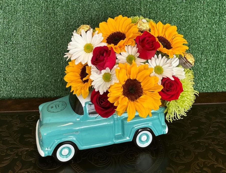 Pick up Bouquet - Light blue car with flowers  Picture is a reference every arrangement would not be exactly the same and flower and color substitution may apply