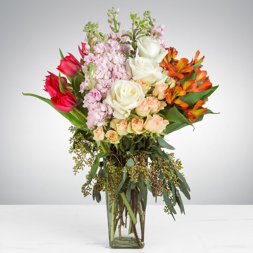 Soft Burn by BloomNation™ - This arrangement contains alstroemeria, tulips, roses, and other seasonal blooms. APPROXIMATE DIMENSIONS: 13" L x 11" W x 22" H
