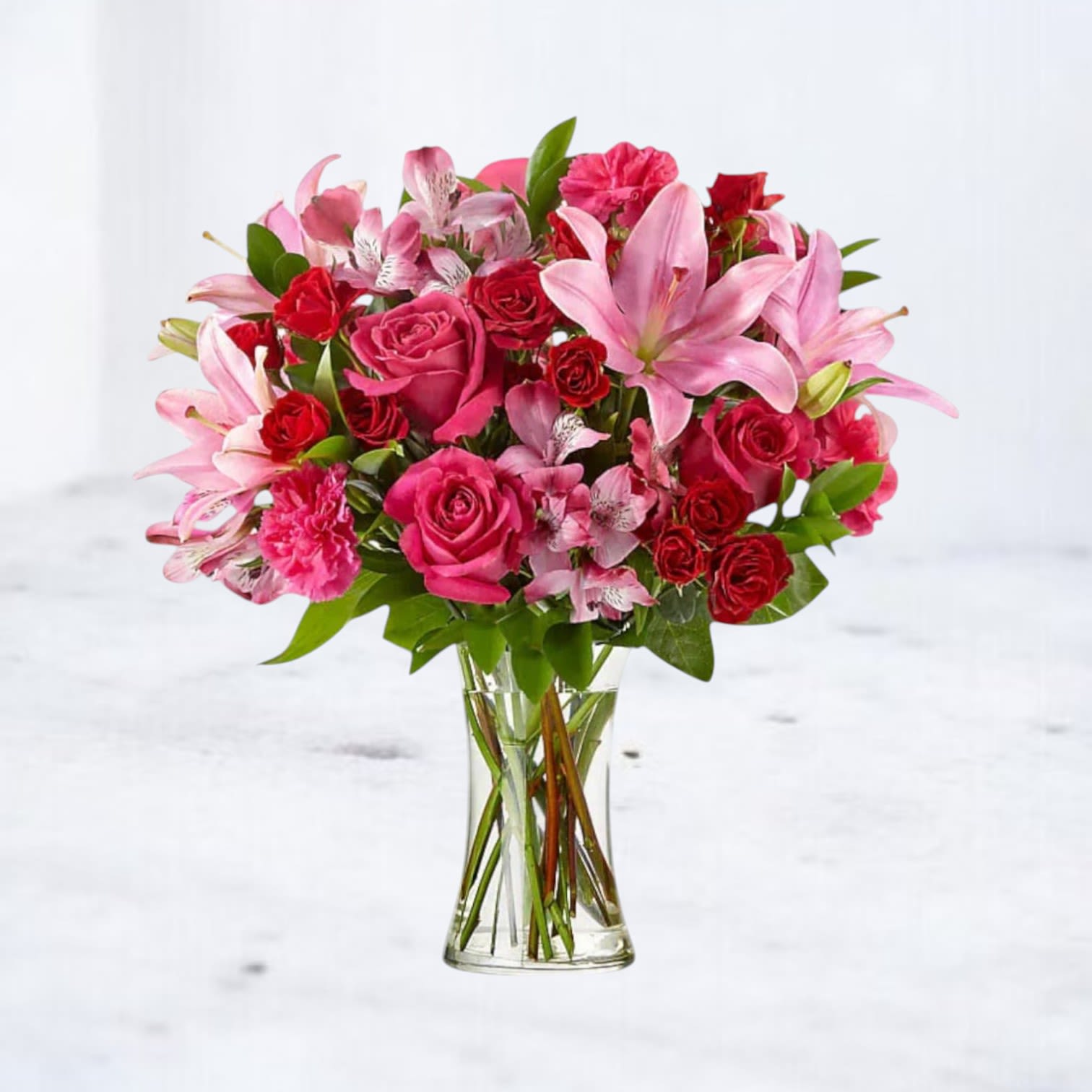 Sweetheart Blossoms - This stunning bouquet features vibrant hot pink roses and elegant pink lilies, creating a breathtaking display of love and affection. The hot pink roses symbolize deep admiration and passion, while the soft pink lilies add a touch of purity and devotion.