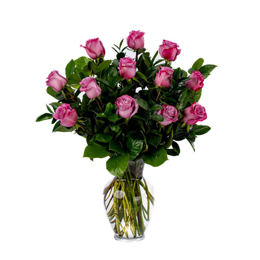 One Dozen Lavender Roses - Our classic 1 dozen lavender roses are designed with long-stem 70 cm roses, rich greens in a 11" clear glass rose vase. RL12 