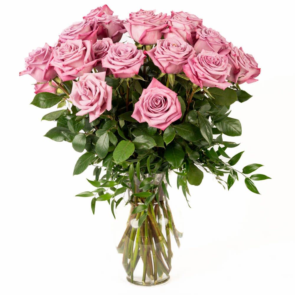 18 Lavender Roses - Our classic 18 lavender roses are designed with long-stem 70 cm roses, rich greens in a 11" clear glass rose vase. 