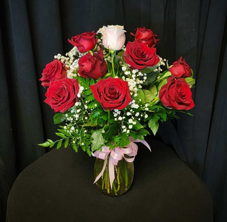 My One and Only - This special Valentine's dozen roses is made with 11 RED roses and one PINK rose to symbolize your "One and Only."  No substitutions on color of roses, limited supply.