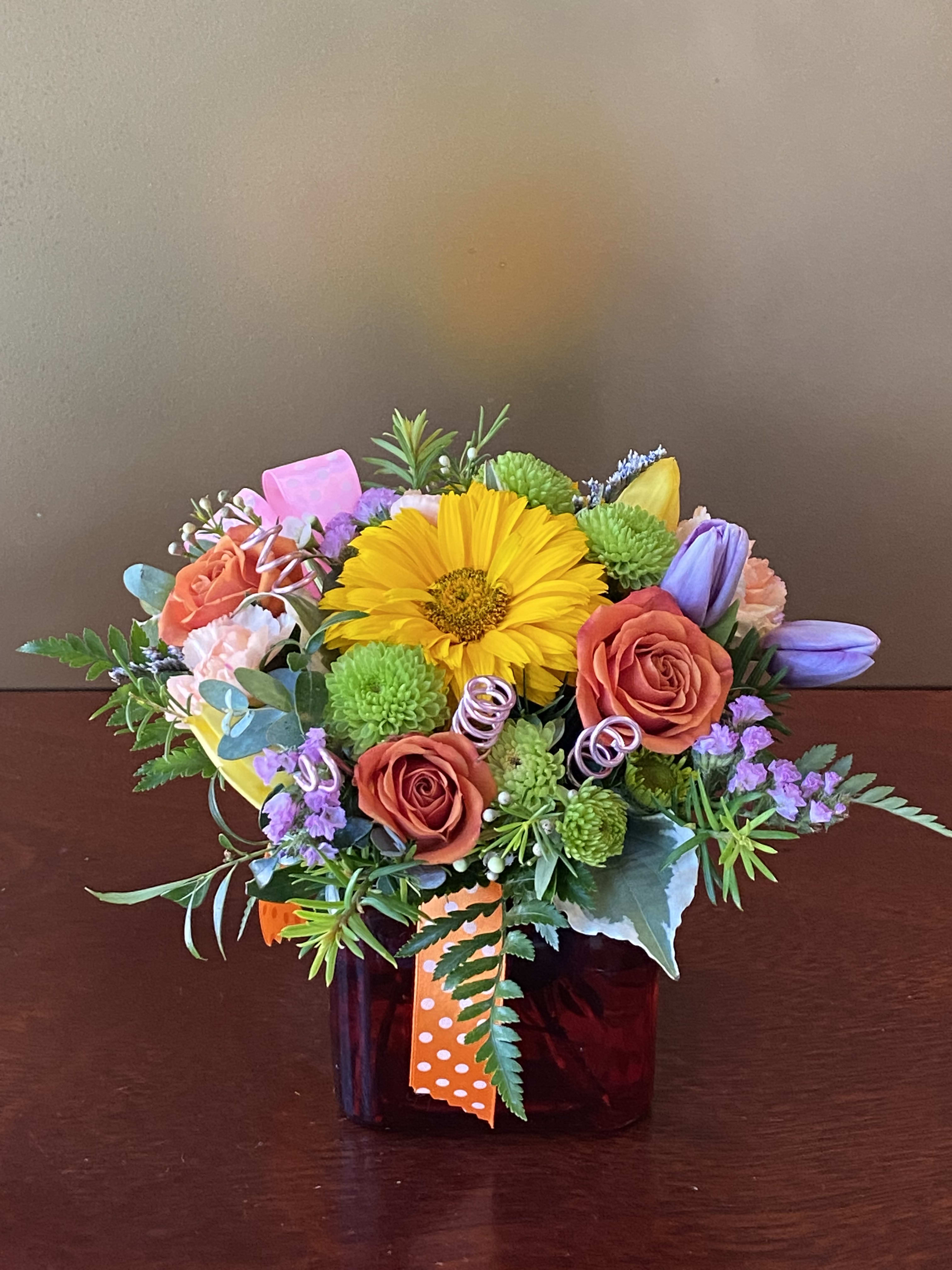 HAPPY THOUGHTS COLORFUL BOUQUET  - Send Happy Thoughts to someone who needs a little cuteness in their life! This adorable, petite flower arrangement is filled with roses, daises, tulips, button poms, carnations, and so much more. With a variety of bright blooms, flowers like these are sure to make them smile!