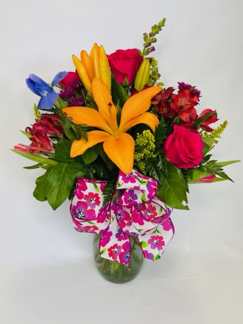 Adoration - Mixed seasonal flowers in a clear container