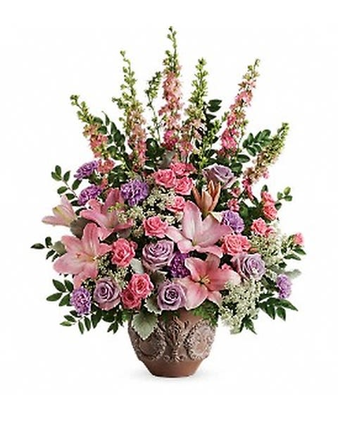 Teleflora's Soft Blush Bouquet  - A touching tribute to a beloved woman, this beautiful, soft pink and lavender arrangement is presented in a large antiqued pot for an elegant touch.  *SUBSTITUTION POLICY* All arrangements may be subject to substitution due to availability of flowers 
