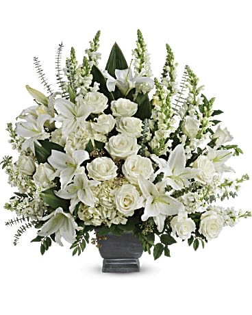 Teleflora's Tre Horizon Bouquet - White hydrangea, white roses, white oriental lilies, white snapdragons, and white stock are arranged with huckleberry, seeded eucalyptus, spiral eucalyptus, green ti leaves, and lemon leaf.