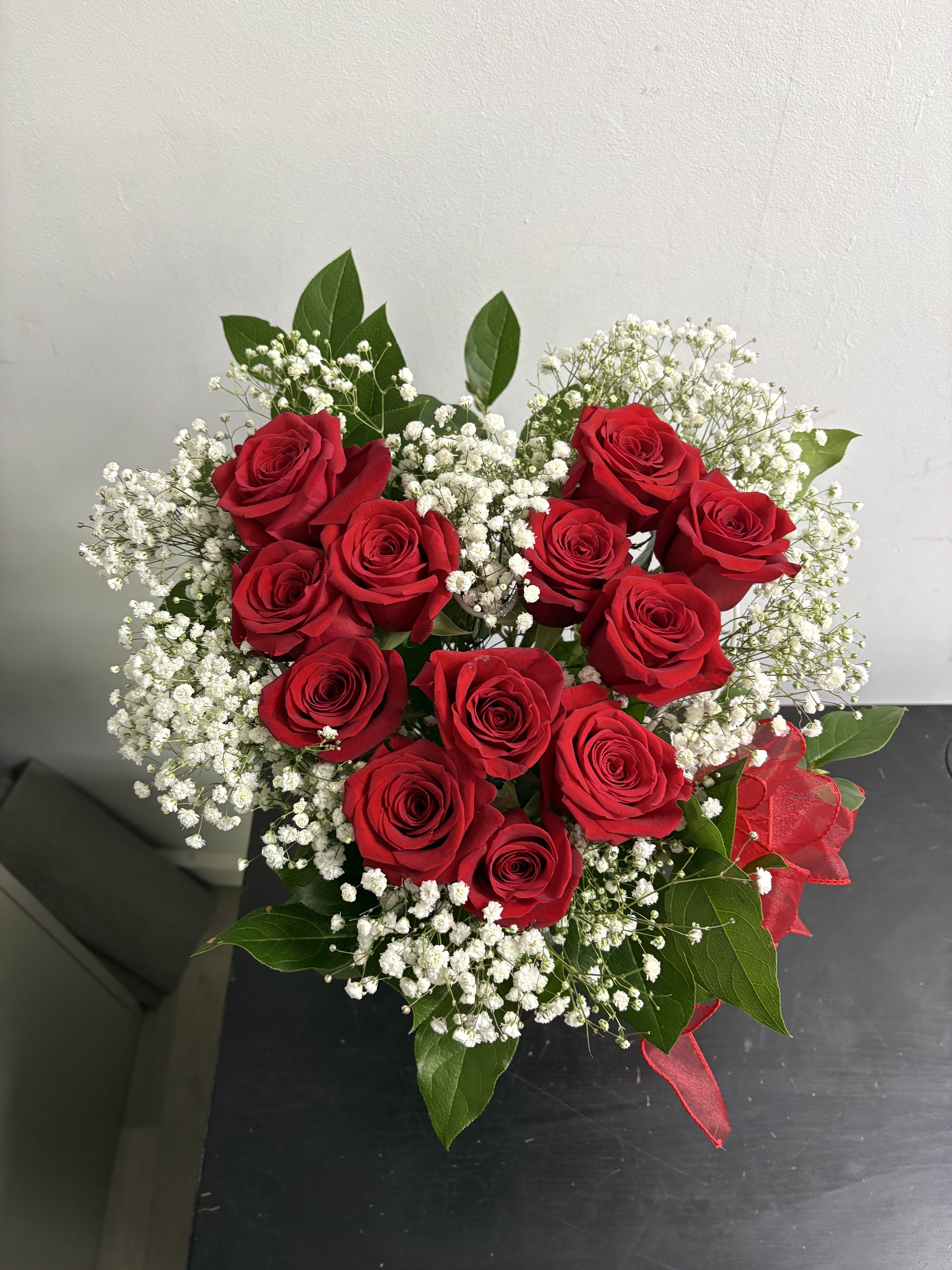 I Heart you - One dozen red roses, babys breath and lemon arrangement in a heart shape 