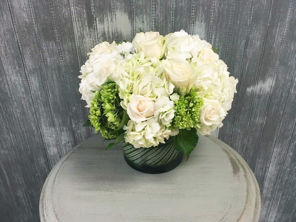 Classic Serendipity - White and green arrangement of hydrangeas and roses perfect for a stylish modern chic centerpiece. 
