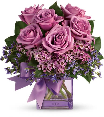  Morning Melody - Shades of purple are in perfect harmony in this profoundly pretty arrangement. A lovely mix of classic and modern ribbons and roses it's sure to make someone's day! Lavender roses and waxflower purple limonium and greens are hand-delivered in a lavender cube that's all wrapped up with a vibrant purple taffeta ribbon.Approximately 10 1/2" W x 11" H Orientation: One-Sided As Shown : T68-3ADeluxe : T68-3BPremium : T68-3C