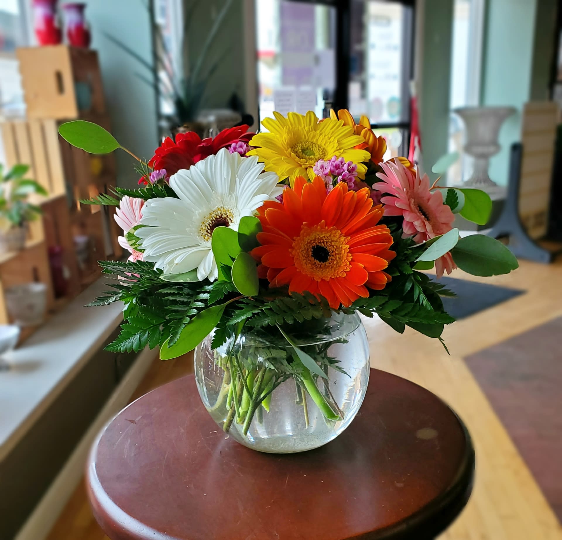 Spring Fling  - Put a spring in her step with this beautiful assortment of six colorful Gerber Daisies in a bubble bowl. 