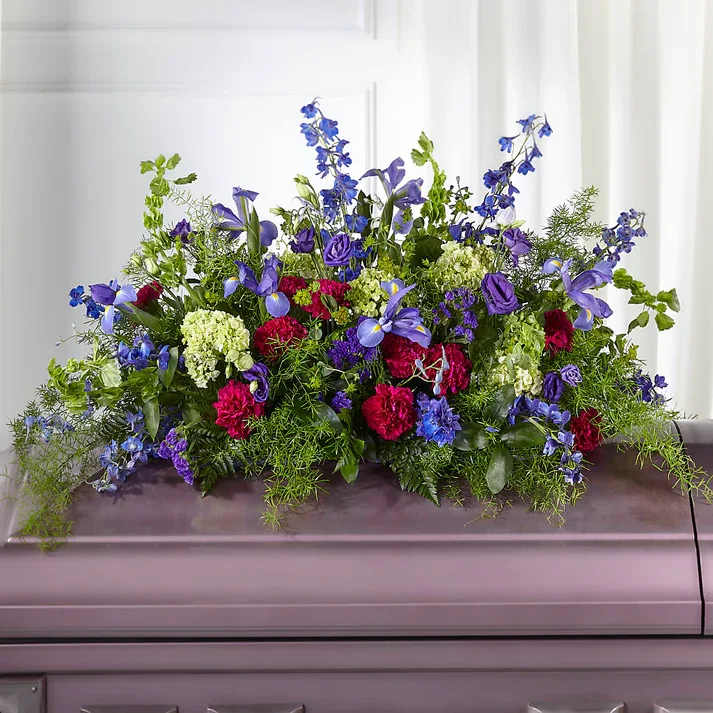 Always Treasured Casket Spray - Serenity and radiance are captured with this gorgeous display of wildflowers. Our talented designers uniquely craft hydrangea, lisianthus, Bells of Ireland and iris to honor a loved one.  Details 20" H x 42" W