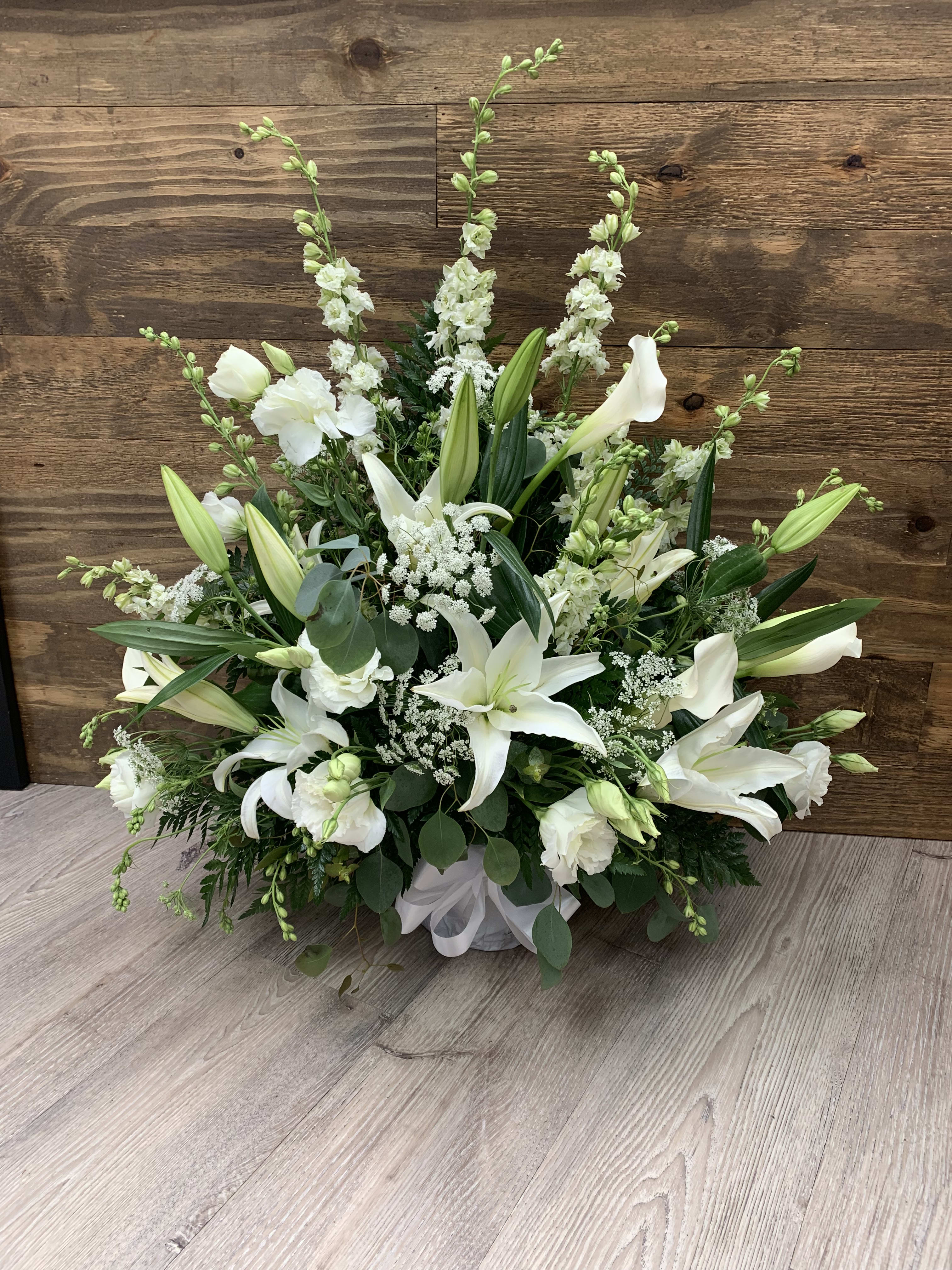 Heavenly Peace - An elegant all white arrangement will bring comfort to a bereaved family and let them know they are in your deepest thoughts.