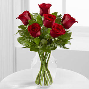  Simply Enchanted Rose Bouquet - Six Red roses are arranged in a sparkling glass vase, and accented with a variety of foliages. 