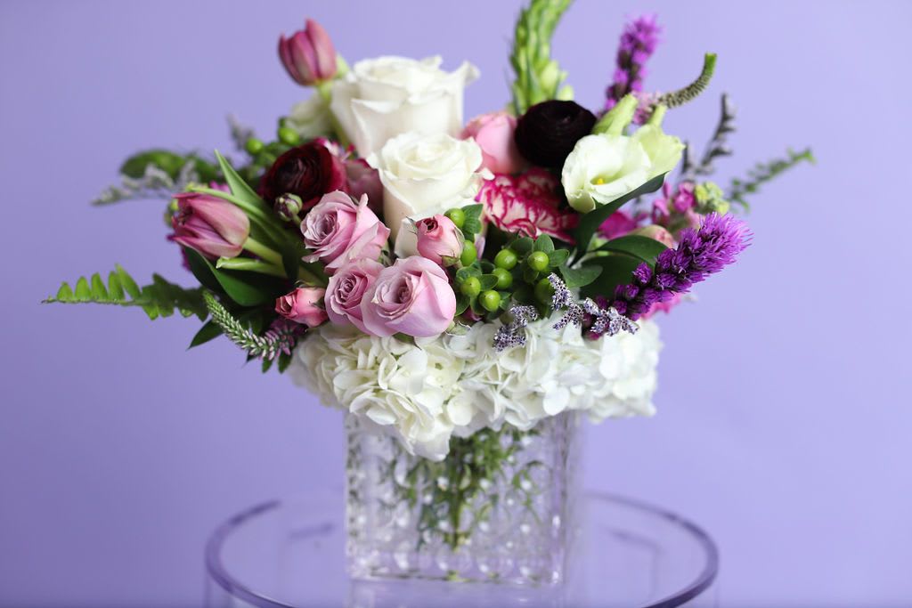 Violet Gardens Standard  - Violet Gardens Standard is a lush, garden-inspired cube arrangement featuring premium white hydrangea, blush and lavender roses, tulips, ranunculus, lisianthus, and seasonal violet accents. Designed in a modern clear glass cube vase, this romantic floral design blends soft pinks, purples, and crisp whites for an elegant, timeless look.  Perfect for birthdays, anniversaries, Valentine’s Day, Mother’s Day, or everyday luxury.  Handcrafted by Bloom-A-Round Floral Design and available for flower delivery in Flower Mound, Southlake, Coppell, Plano, Frisco, Denton, and surrounding DFW areas.  Seasonal substitutions may apply to maintain freshness and design integrity.