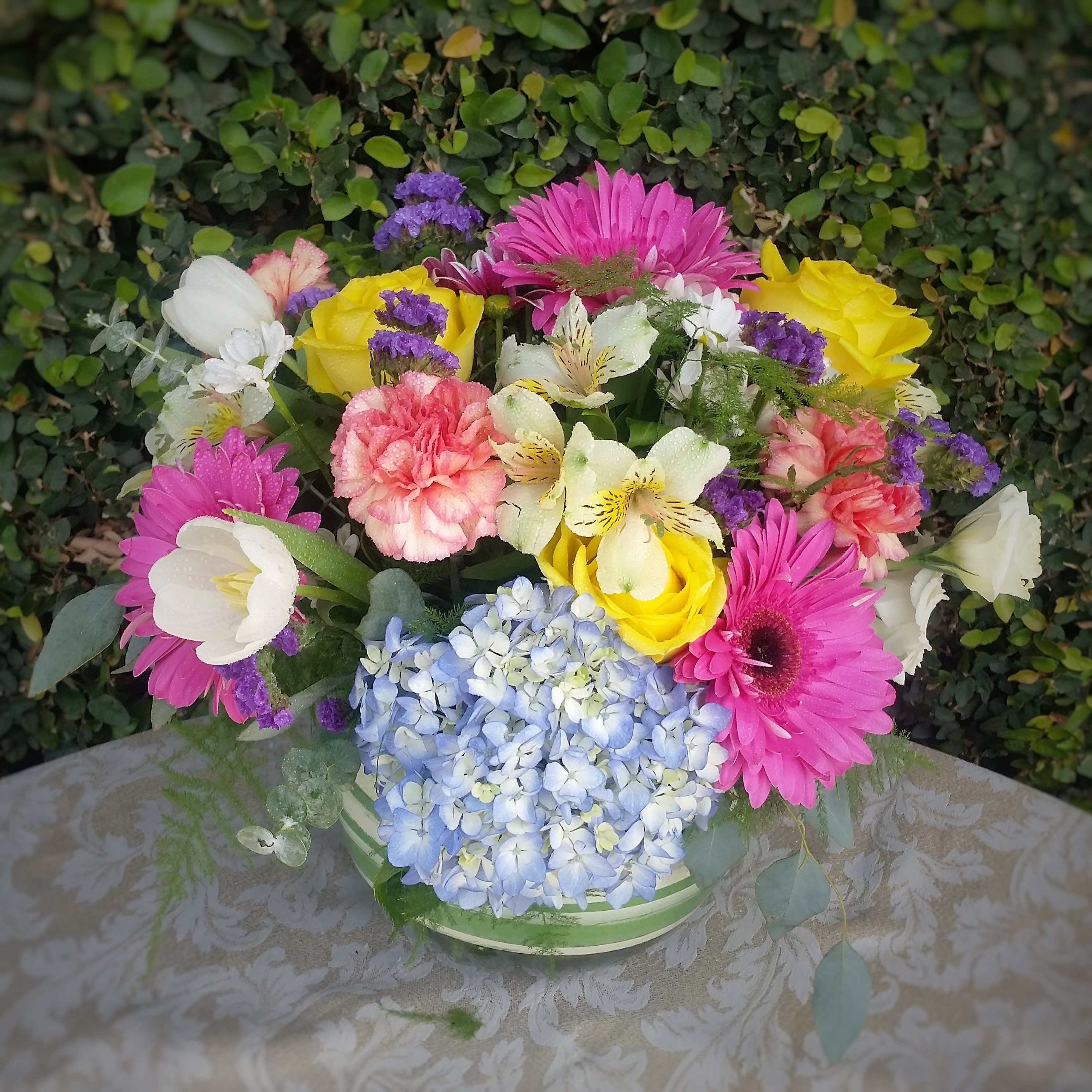 Colorful Spring - Beautiful, Colorful Mixture of Gerberas, Roses, Carnations, Alstroemeria Daisies, Tulips, Lisianthus and Statice designed in a lined bubble bowl. Perfect for the Easter Celebration!