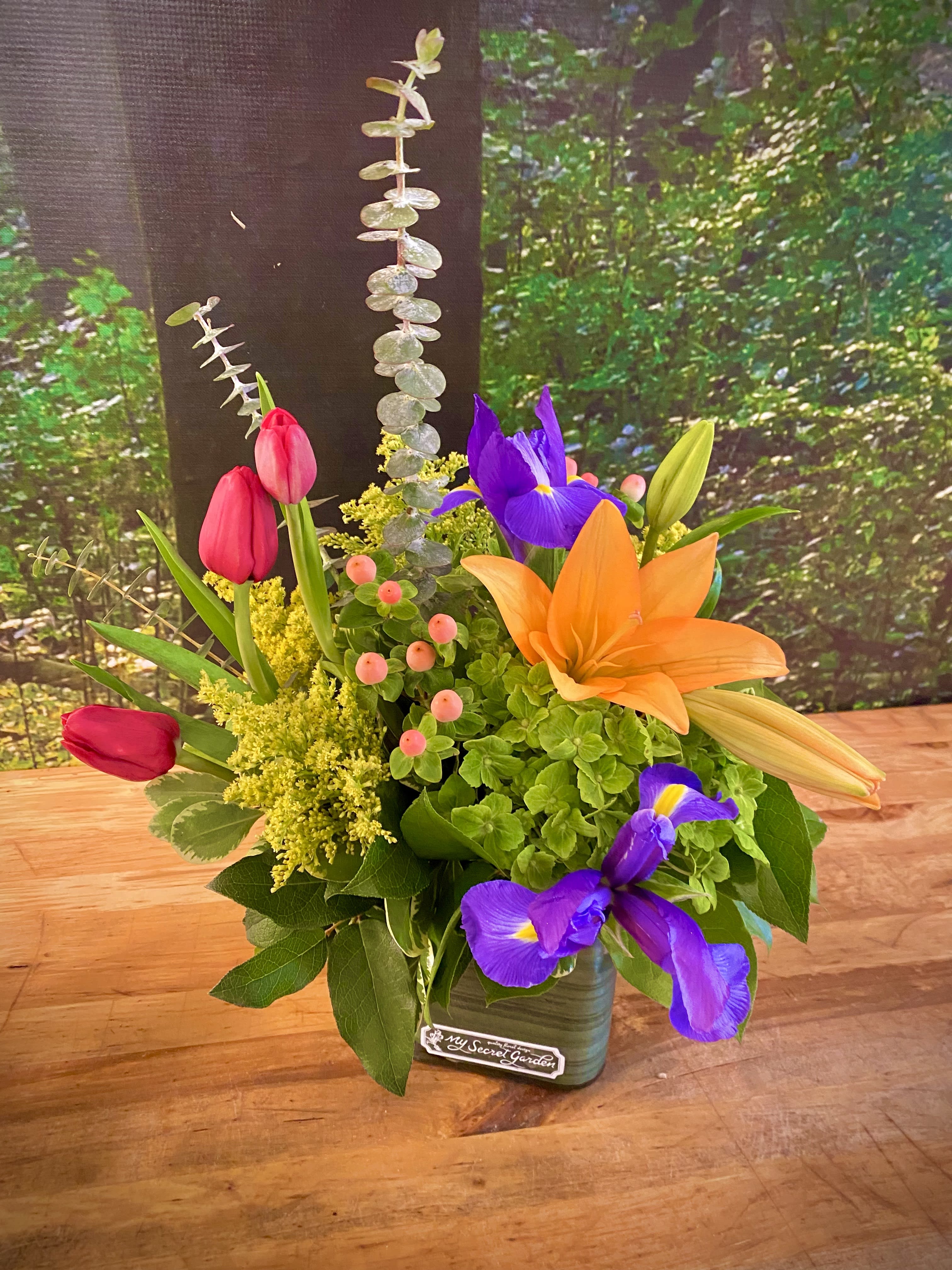 Sweet Garden -  A sweet and petite design to show just how much you care! This colorful and full design features Tulips, Iris, and Lilies.