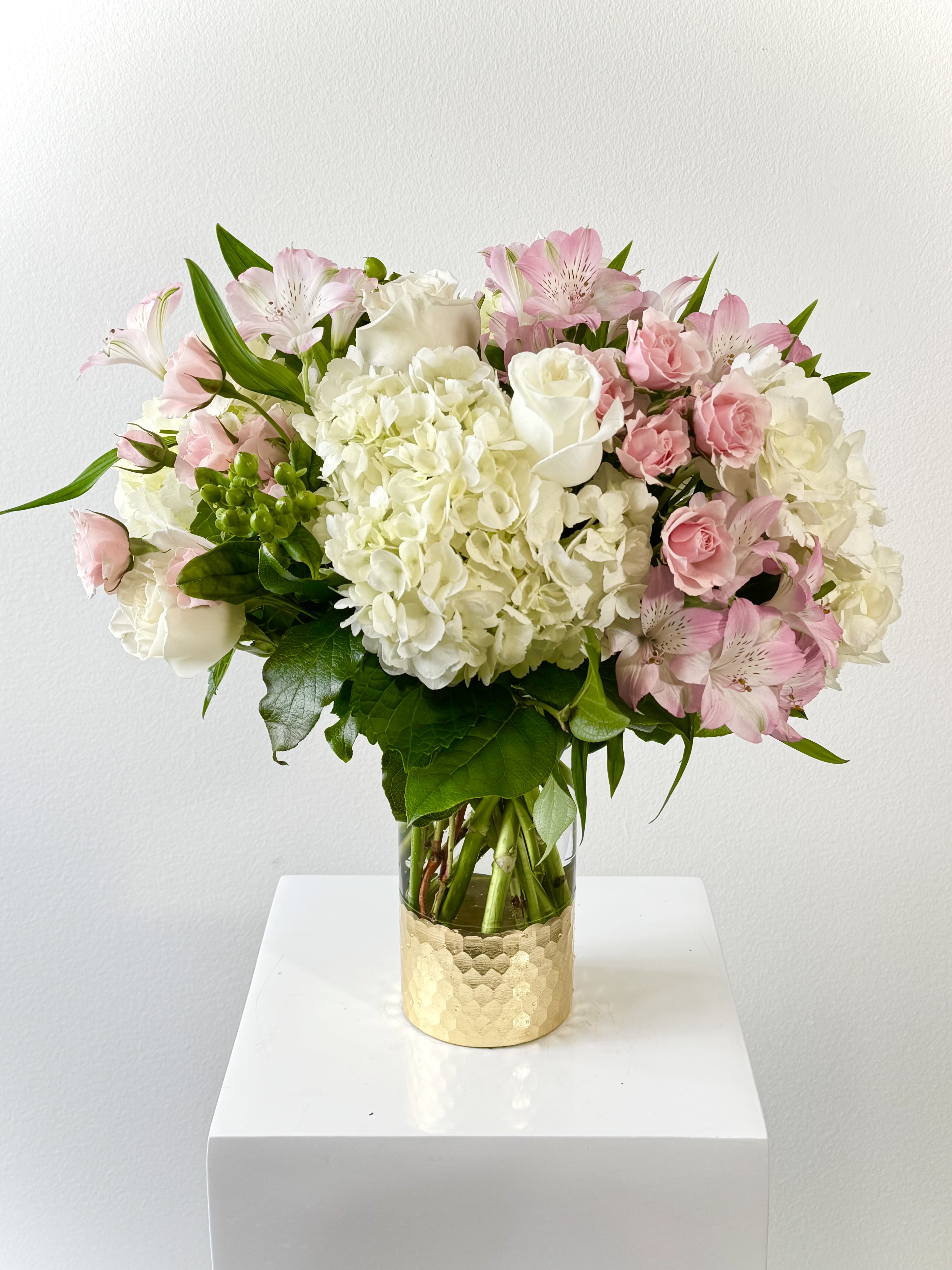 Parisian Stroll - Step into a whimsical daydream with the Parisian Stroll bouquet from Irvine Village Flowers, where soft pinks pirouette in a charming waltz! This darling arrangement of hydrangeas, roses, spray roses, and alstroemeria, dressed in whispers of white and blush, blooms like a love letter from a Parisian spring. Each petal tells a story of romance, as if plucked from a stroll along the Seine.  Hydrangeas: Fluffy as cotton candy clouds, they fluff up dreams with tender charm.  Roses: Timeless beauties, blushing pink, murmur sweet nothings of love.  Spray Roses: Tiny, playful blooms that giggle in delicate clusters.  Alstroemeria: Dainty and devoted, they sprinkle joy like confetti.  This pink-kissed bouquet, a swirl of whimsy, invites you to twirl through moments of delight. Order now and let Irvine Village Flowers sweep you away.