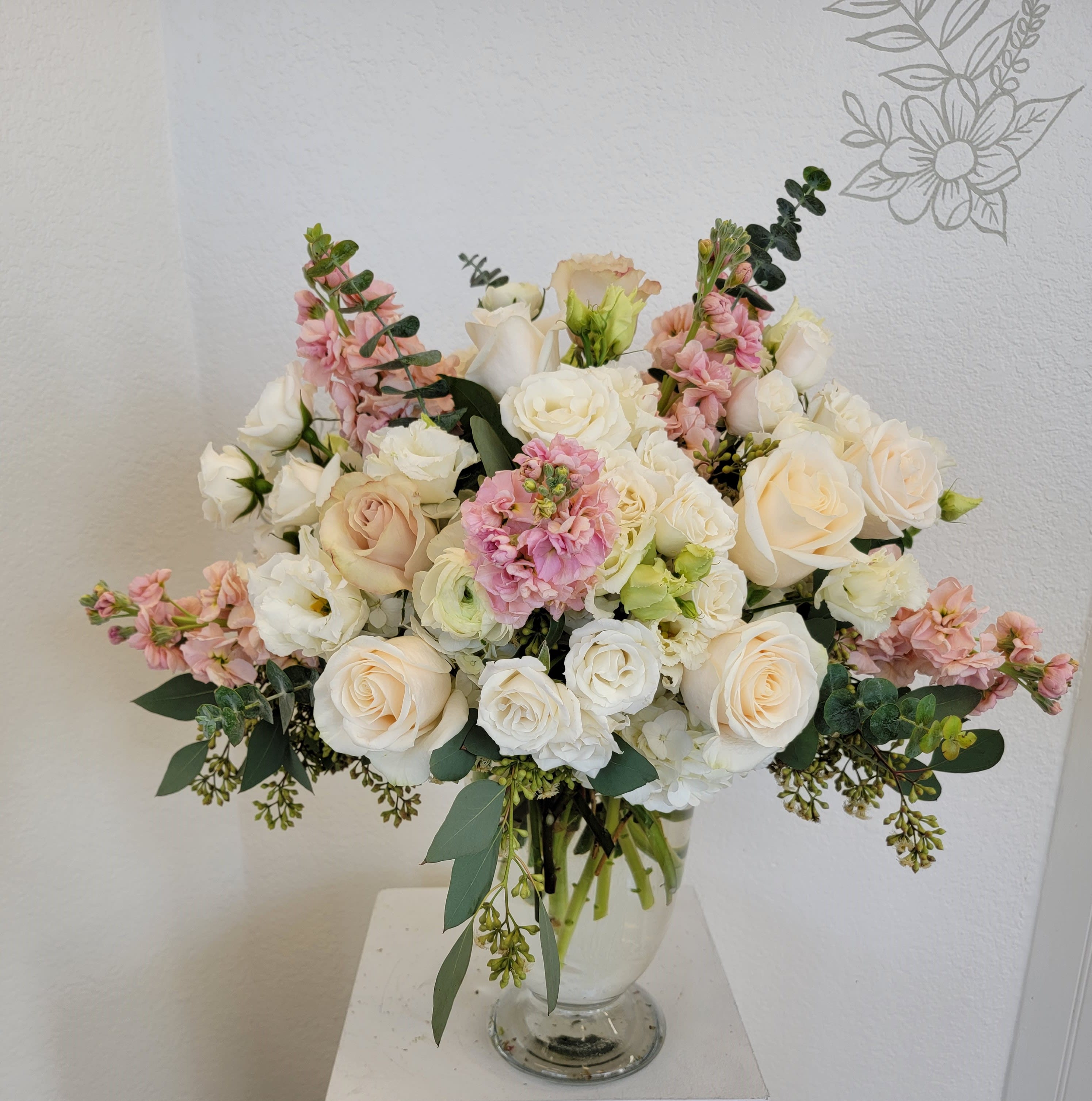 The Elegant Bouquet - A taller version of our muted elegance. Arrangement includes roses, spray roses, stock, lisianthus and ranunculus. 