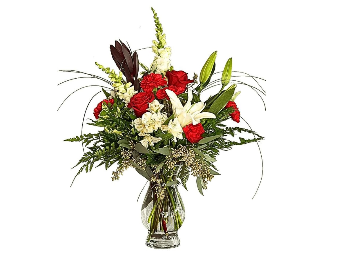 Rubies and Diamonds - Sparkling, precious, and perfect! Rubies and Diamonds will bring a twinkle to your loved one's eyes. Flowers like lilies, carnations, and roses in red and white hues are real gems in this arrangement. Approximately 25"W X 26"H  Container may vary based upon availability.
