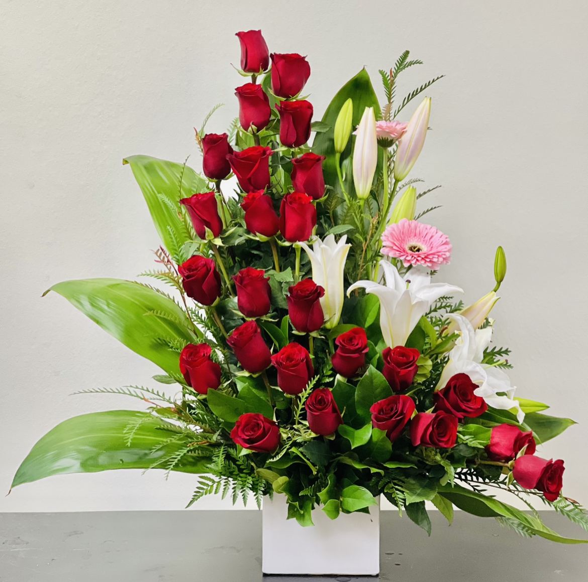 BF-V14 Be My Valentine - 25 Red Roses with Lilies - 25 premium red roses, white lilies, and pink gerbera daisies, meticulously arranged in an artistic design, exuding elegance and love in every petal.