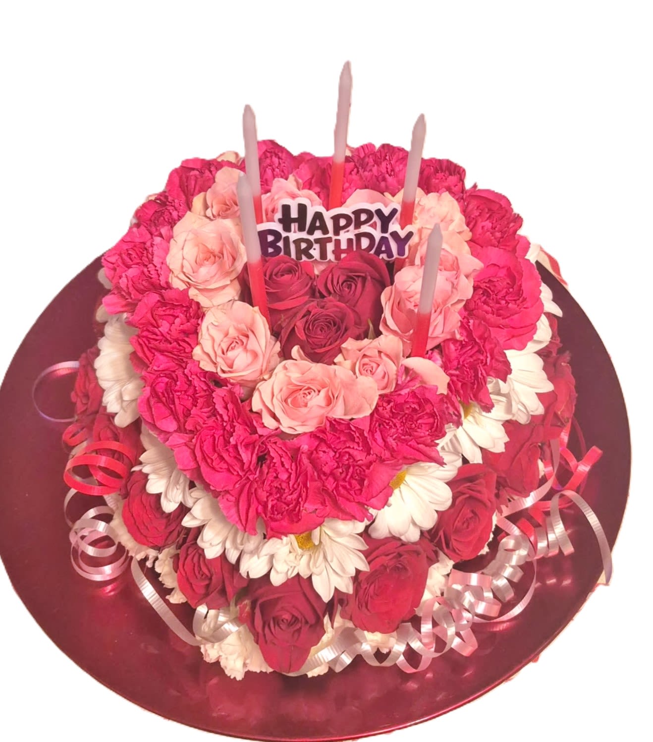 February Birthday Cake - The heart shaped floral cake will surprise and delight any birthday recipient. Made with red, white and pink spray roses, and assorted flowers, ribbon, and candles. Perfect for a February Birtthday!