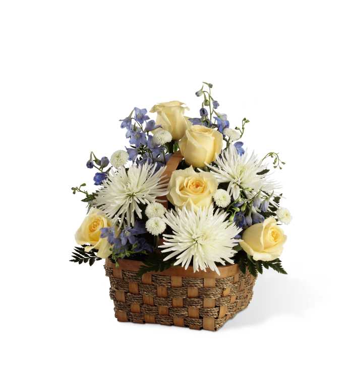 The FTD Heavenly Scented Basket - The FTD Heavenly Scented Basket is bursting with a collection of vibrant blooms to convey your deepest sympathies for their loss. Cream roses, light blue delphinium, white spider chrysanthemums, white button poms and lush greens create a sweet presentation, arranged in a natural woven rope basket, to make their day just a little bit brighter with its elegant beauty.