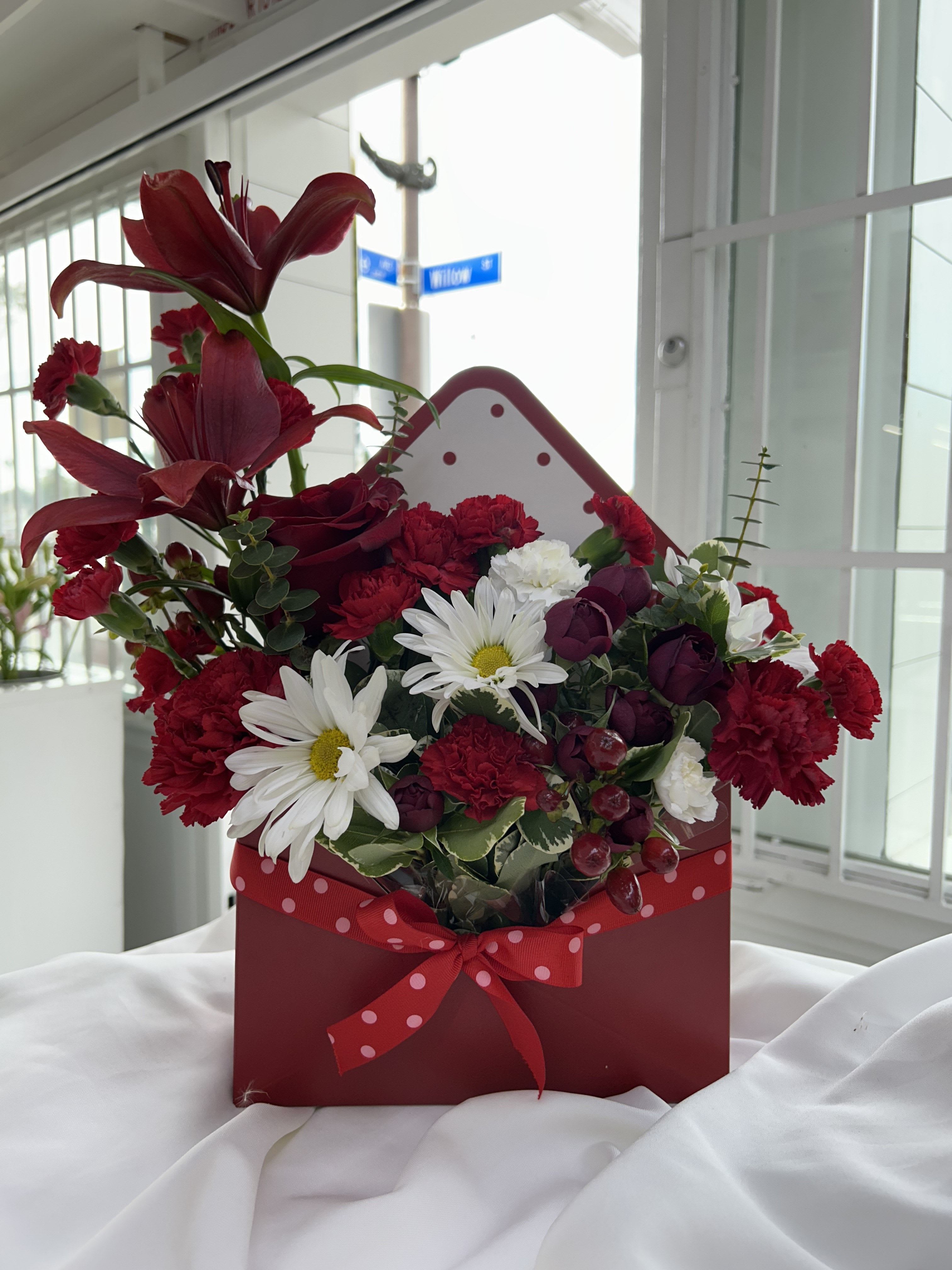 Love Letter Blooms - A romantic heartfelt vibe with a red and white flowers.  Substitutions: If some flowers and/or the vase are not available there will be minor substitutions.  