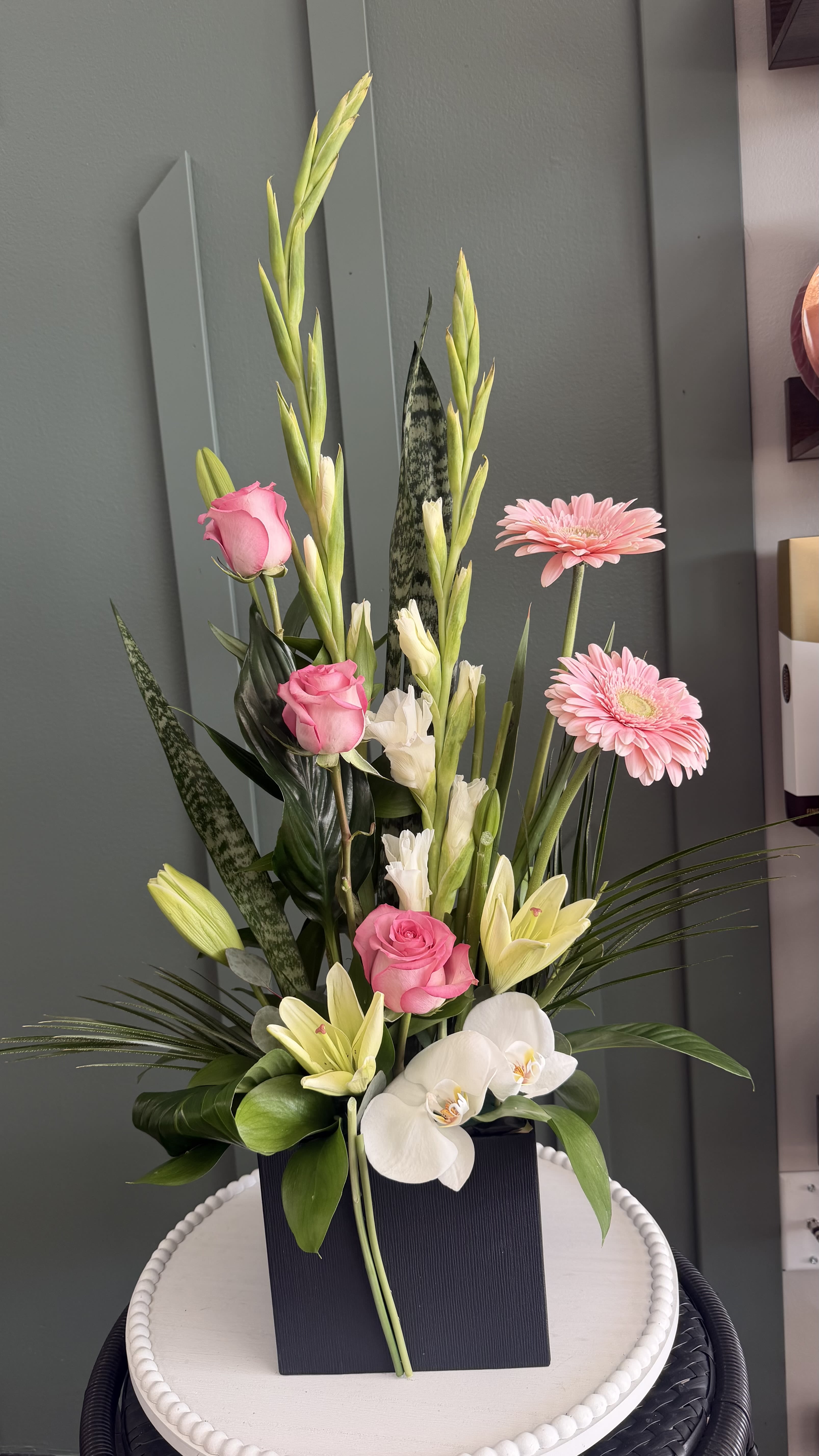 	Timeless Beauty - Blush pink roses and gentle white flowers come together in a tall, graceful design accented with fresh greenery. This arrangement offers a serene and refined look, making it a beautiful gift for any occasion.