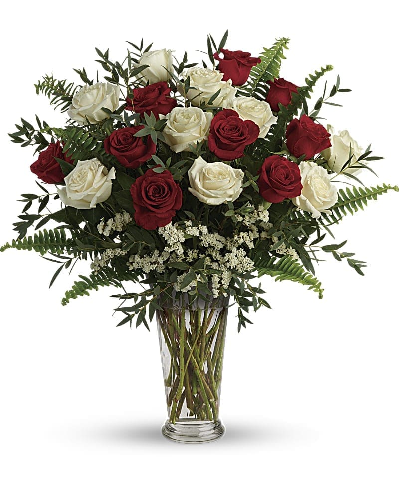 Yours Truly Bouquet  - Mixed Long Stemmed Roses - Make your special someone feel truly loved by surprising them with this extraordinary bouquet! A dozen and a half red and white roses are artfully arranged in a classic vase with delicate greens. This bouquet includes red roses, white roses, white sinuata statice, parvifolia eucalyptus, and sword fern. Delivered in a clear romanesque vase.