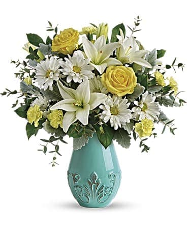 Aqua Dream - What dreams are made of! Inspired by sunny spring mornings, this bright, cheerful bouquet of yellow roses, white lilies and happy daisies is presented in a glorious, aqua-glazed ceramic vase with distressed details.  Orientation: One-Sided  This dreamy arrangement of yellow roses, white asiatic lilies, yellow miniature carnations, and white daisy spray chrysanthemums is accented with dusty miller, parvifolia eucalyptus, and lemon leaf. Delivered in an Aqua Dream Vase.  Orientation: All-Around