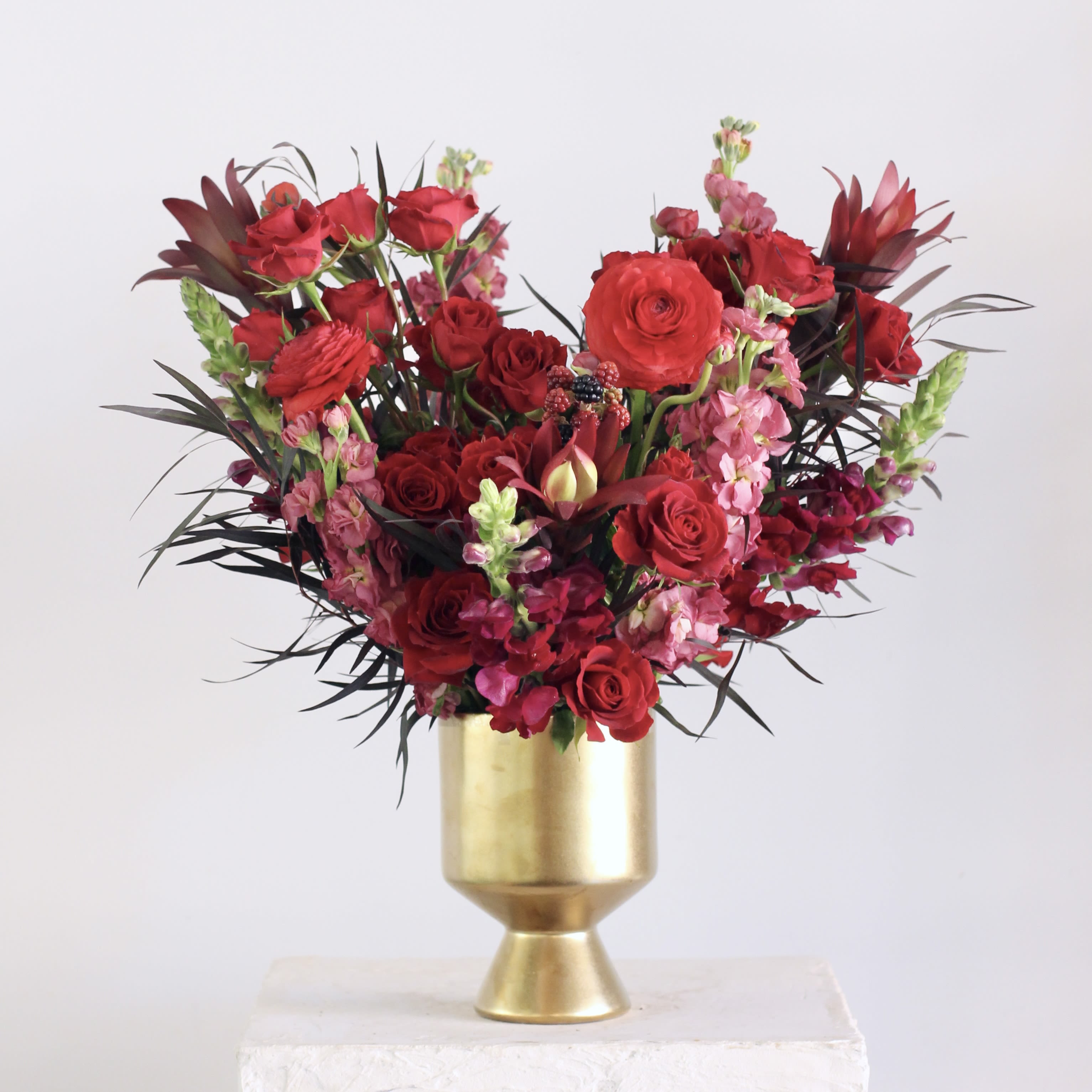 Rouge - Bold, romantic, and full of drama, the Rouge floral arrangement is a stunning blend of deep reds, burgundy, and magenta blooms. All showcased in an elegant gold container, it’s perfect for any occasion that calls for a touch of luxury!  Delivery Policy: At Middlemist, we aim to make every delivery seamless and delightful. It is the sender’s responsibility to ensure the recipient is available to accept delivery between 3–5pm on the scheduled date and that the delivery address is accurate. We will send a text notification to the recipient on the day of delivery. If no one is available to receive the order, it will be returned to the shop and may be picked up or redelivered for an additional delivery fee. If a recipient requests the order be left unattended, we cannot guarantee the condition of the flowers or plants, and no refunds will be issued once an order is left outside.