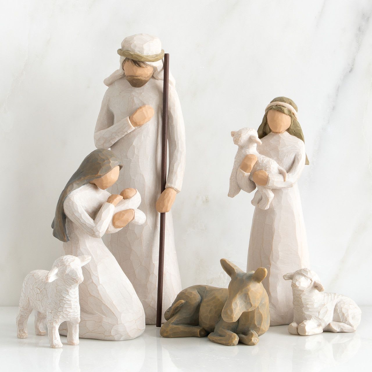 Willow Tree - Nativity (6 pieces) - Six hand-painted resin figures, tallest is 9.5”h. Includes Mary, Joseph, shepherd, donkey and two sheep Six figures: Joseph in cream garment with wood staff; kneeling Mary in cream dresswith blue-gray cape holding baby Jesus in cream blanket; shepherd in cream garment carrying white lamb; gray-blue donkey, two white sheep: one standing, one lying down Dust with soft cloth or soft brush. Avoid water or cleaning solvents
