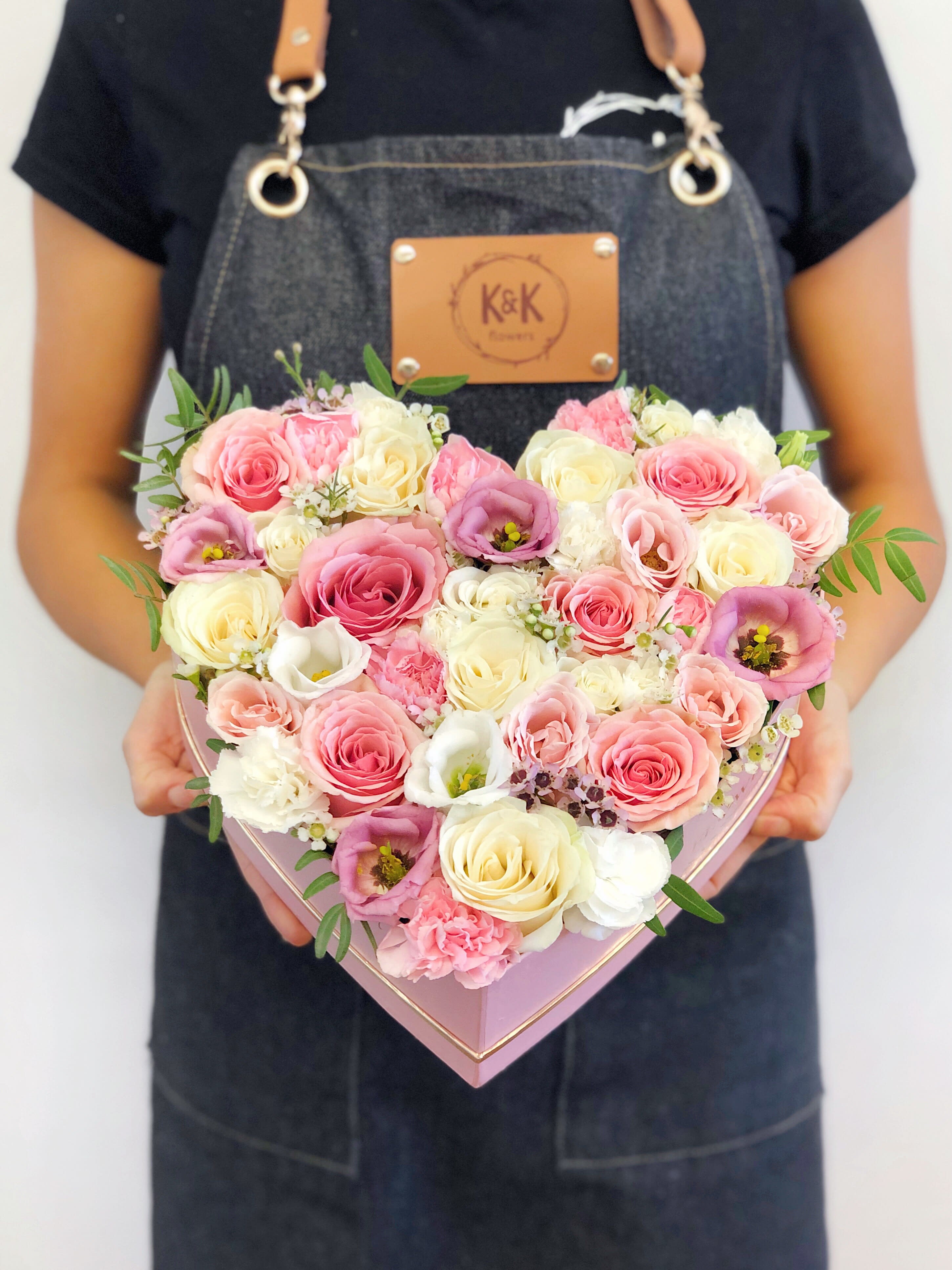 Heart Shaped Box Pink and white - Heart-shaped box filled with roses and spray roses. Flowers in boxes don’t need vases. That makes it perfect for transportation and keeping flowers hydrated and secure.  