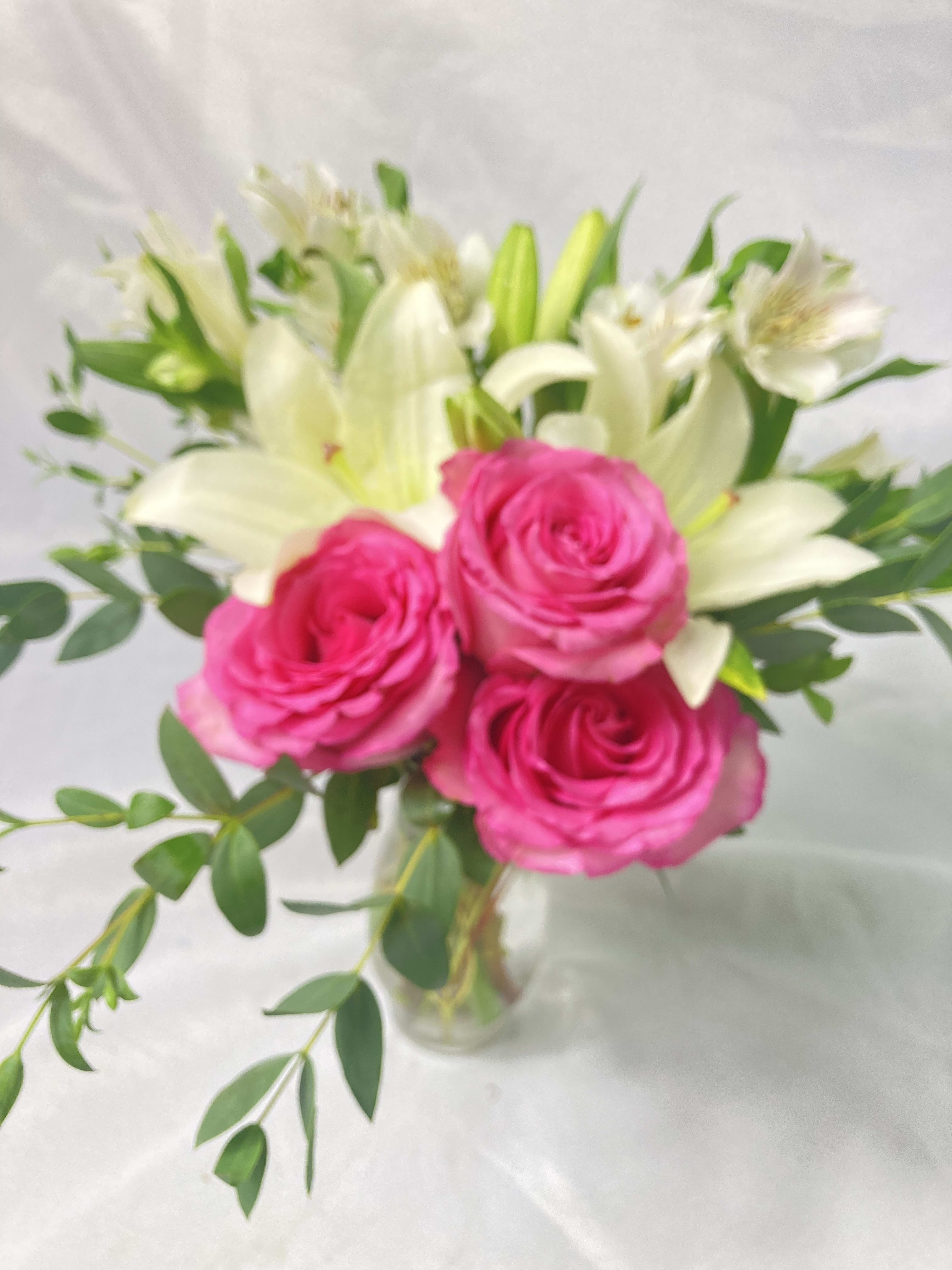 Blissful Elegance Bouquet  - This beautiful bouquet will most certainly arrive in style! Ready for the runway as it were. A delightful combination of light colors and lovely flowers it's simply beautiful. Light pink roses white asiatic lilies alstroemeria cushion spray chrysanthemums and statice are delivered in a stylish vase. Style to spare!