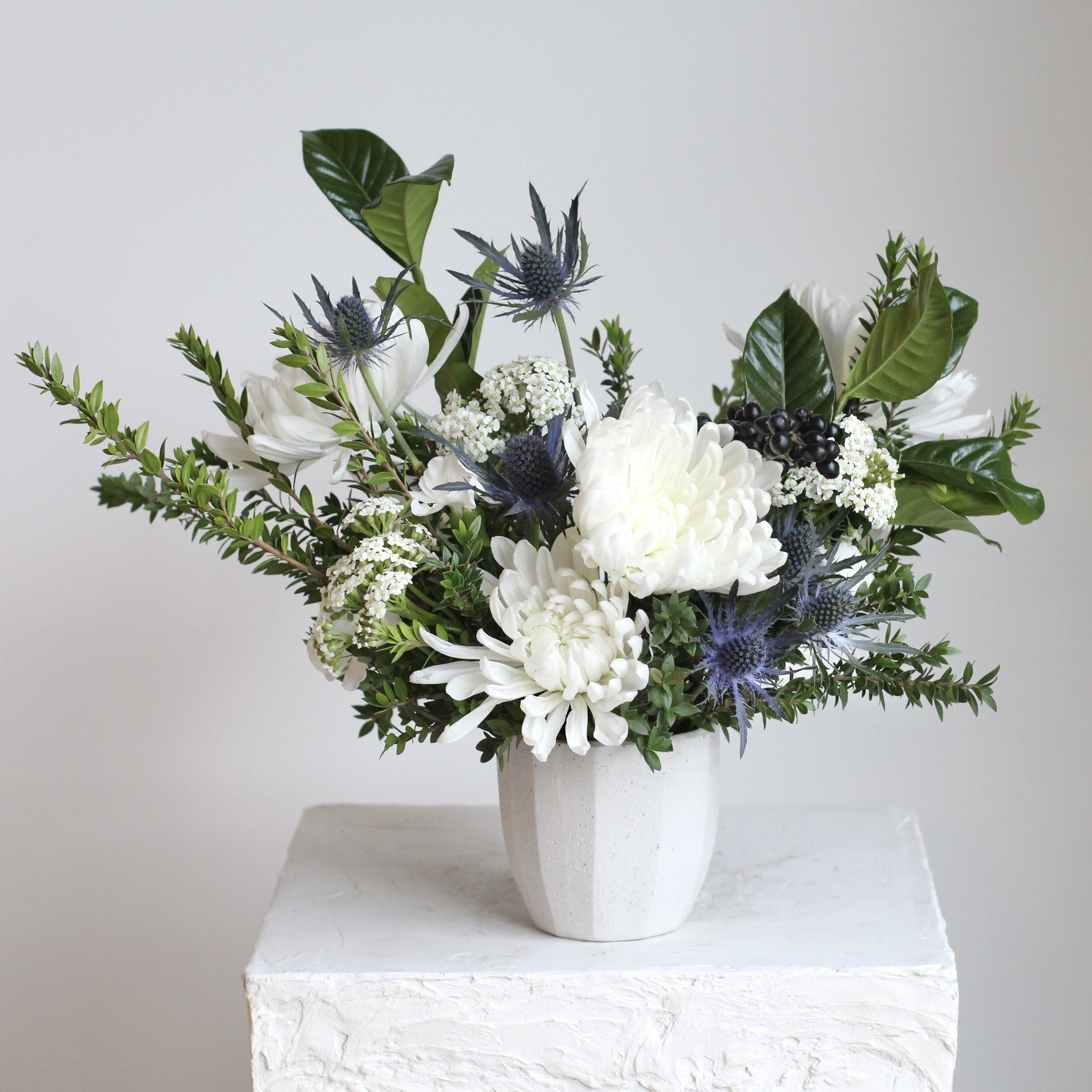 Sapphire &amp; Snow - Delicate blue nigella and orlaya add soft, intricate textures, while fresh myrtle and dark, rich berries provide the perfect accent for a balanced and timeless arrangement.   Whether you're hosting a festive gathering or looking to add a touch of sophistication to your holiday decor, "Sapphire &amp; Snow" is a showstopper. Its clean, elegant design effortlessly complements any setting, making the season feel just a little more magical.    Delivery Policy: At Middlemist, we aim to make every delivery seamless and delightful. It is the sender’s responsibility to ensure the recipient is available to accept delivery between 3–5pm on the scheduled date and that the delivery address is accurate. We will send a text notification to the recipient on the day of delivery. If no one is available to receive the order, it will be returned to the shop and may be picked up or redelivered for an additional delivery fee. If a recipient requests the order be left unattended, we cannot guarantee the condition of the flowers or plants, and no refunds will be issued once an order is left outside.