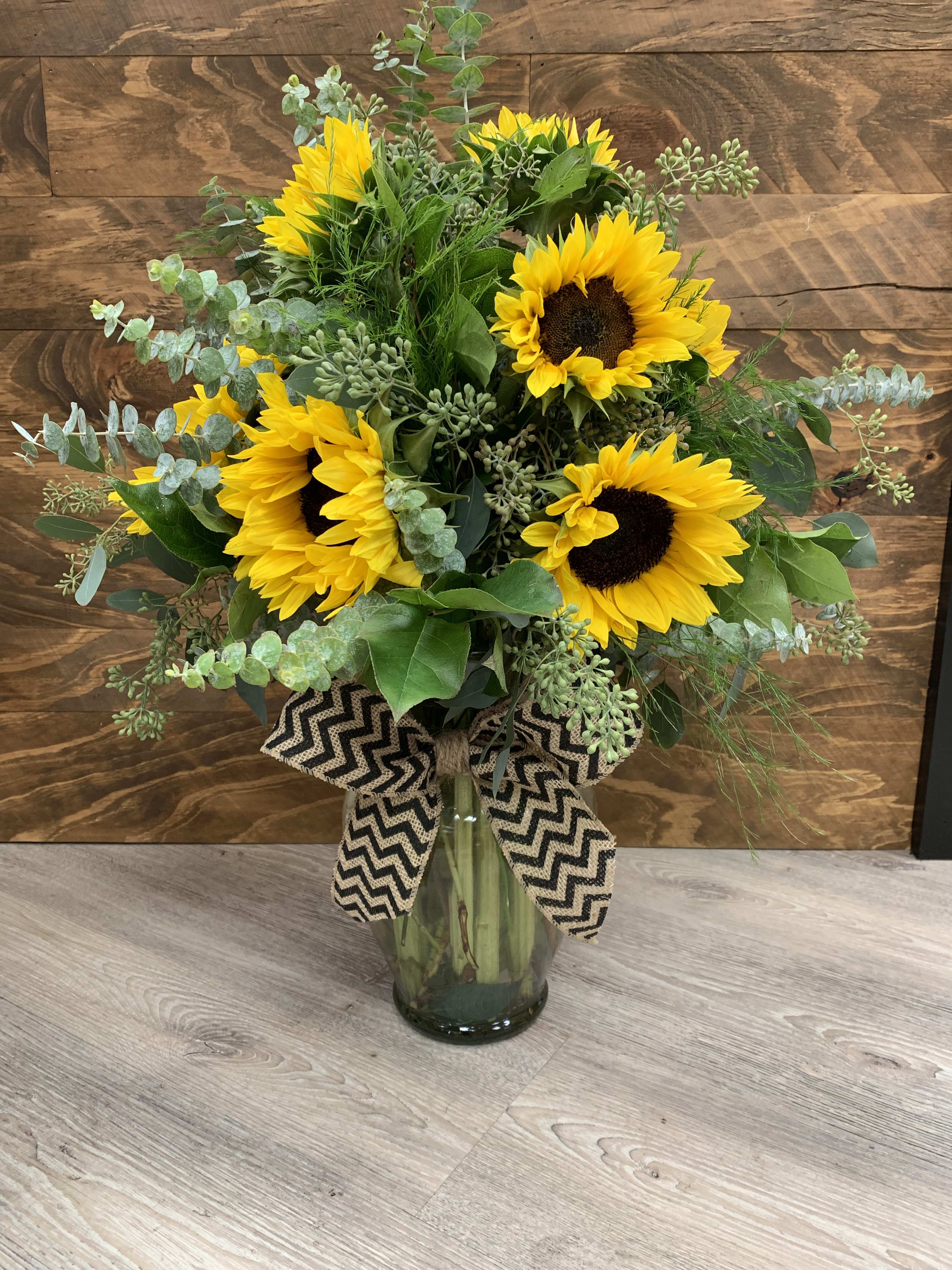 Sunflower Field - This elegant sunflower arrangement is sure to brighten anyones day! This mix of beautiful greens and sunflowers is sure to bring a smile.