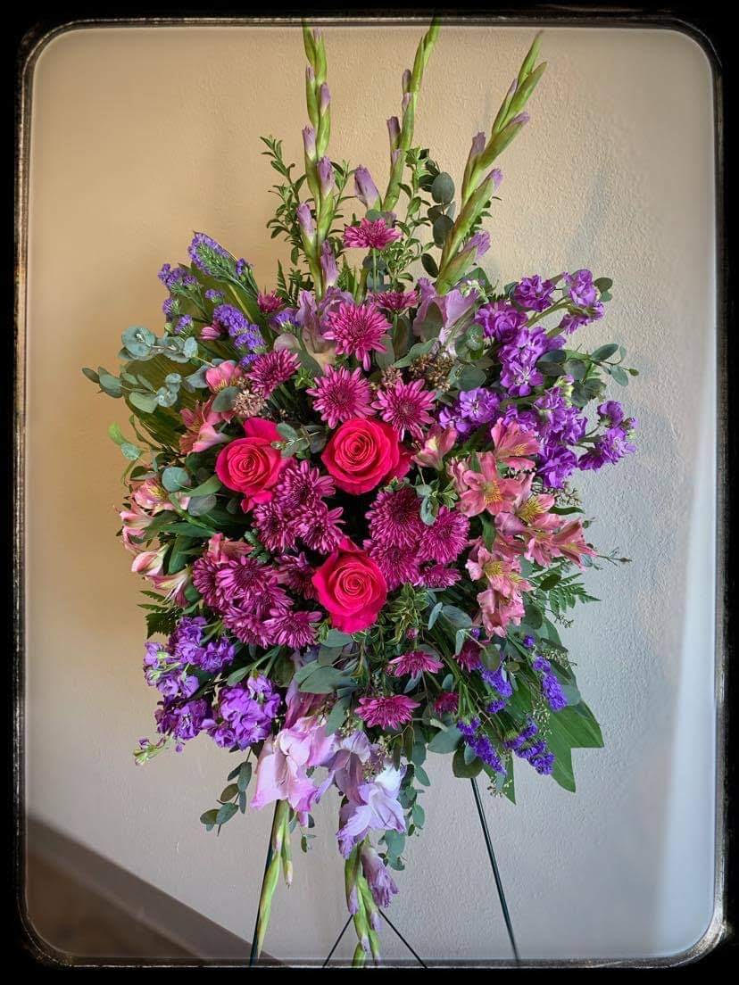 Elegant Easel  - The stunning easel piece of pinks and purples features roses, stock, gladiolus, mums, alstroemeria and more. 