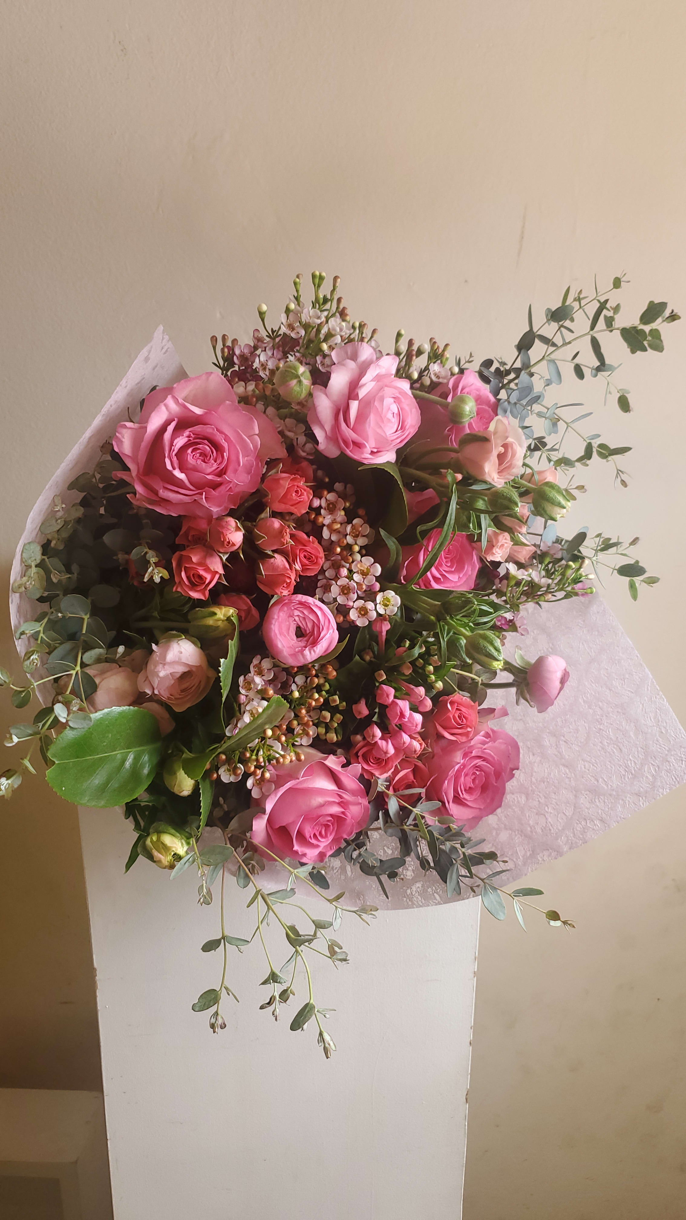 Designers Choice Pink Wrap - Large, lush hand-tied wrapped mixed bouquet using fresh seasonal flowers. Picture is approximate. *Please indicate any specifics in special instruction section*
