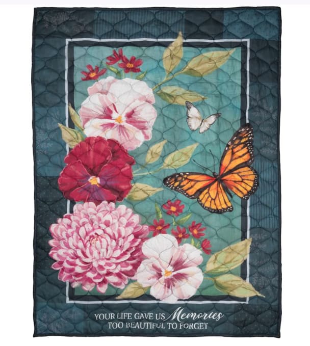 Carson Memories Quilted Blanket - Carson quilted blanket printed with bright colors and a thoughtful sentiment.  "Your life gave us memories too beautiful to forget."  Made from 100% polyester microfiber.  Two loops are sewn in on the reverse side for hanging purposes. Measures 37 inches by 52 inches.  Machine wash separately in cold water on gentle cycle, tumble dry on low-heat.